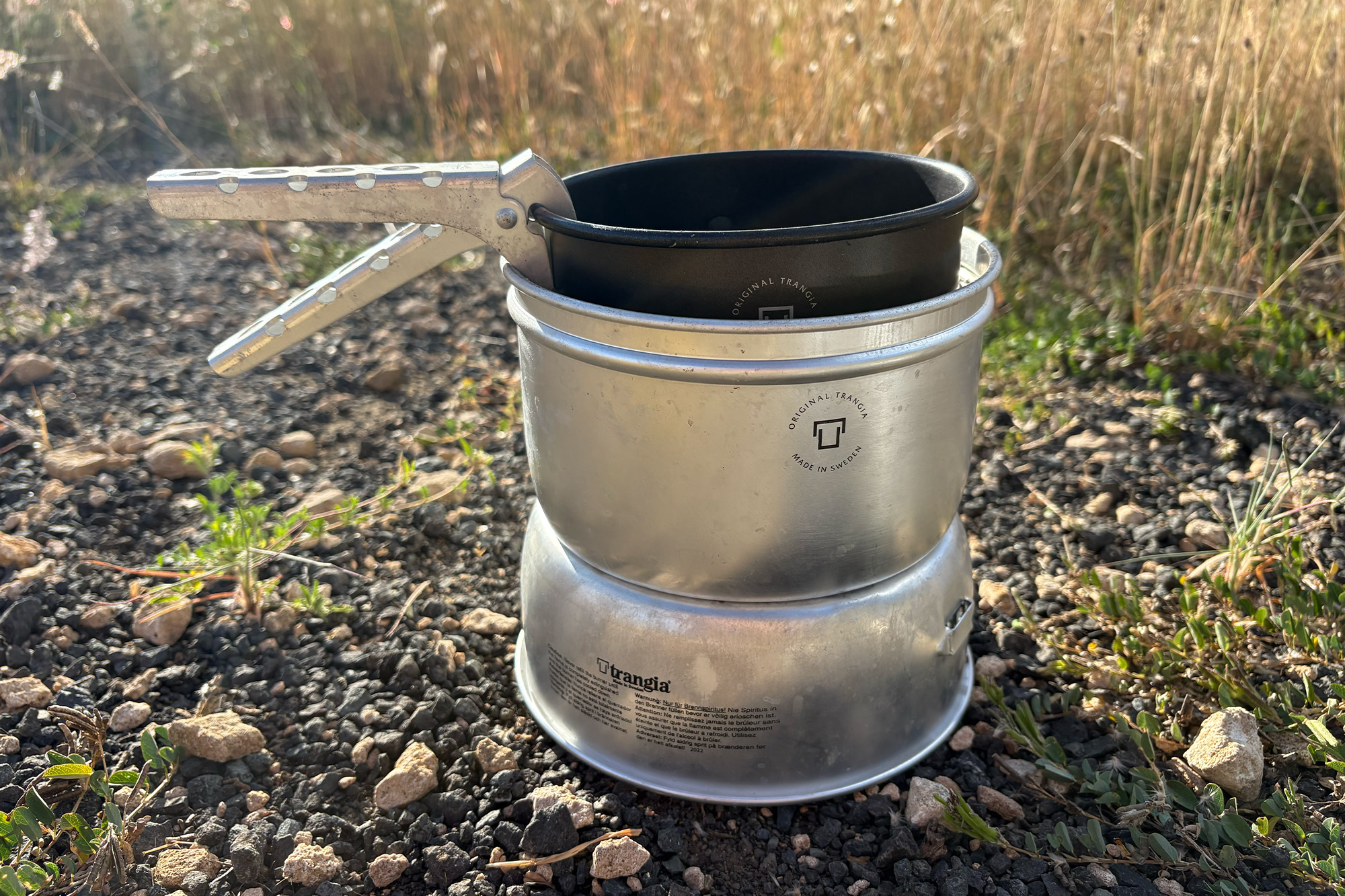 Trangia 27-5 Stove with handle in a rocky outdoor setting