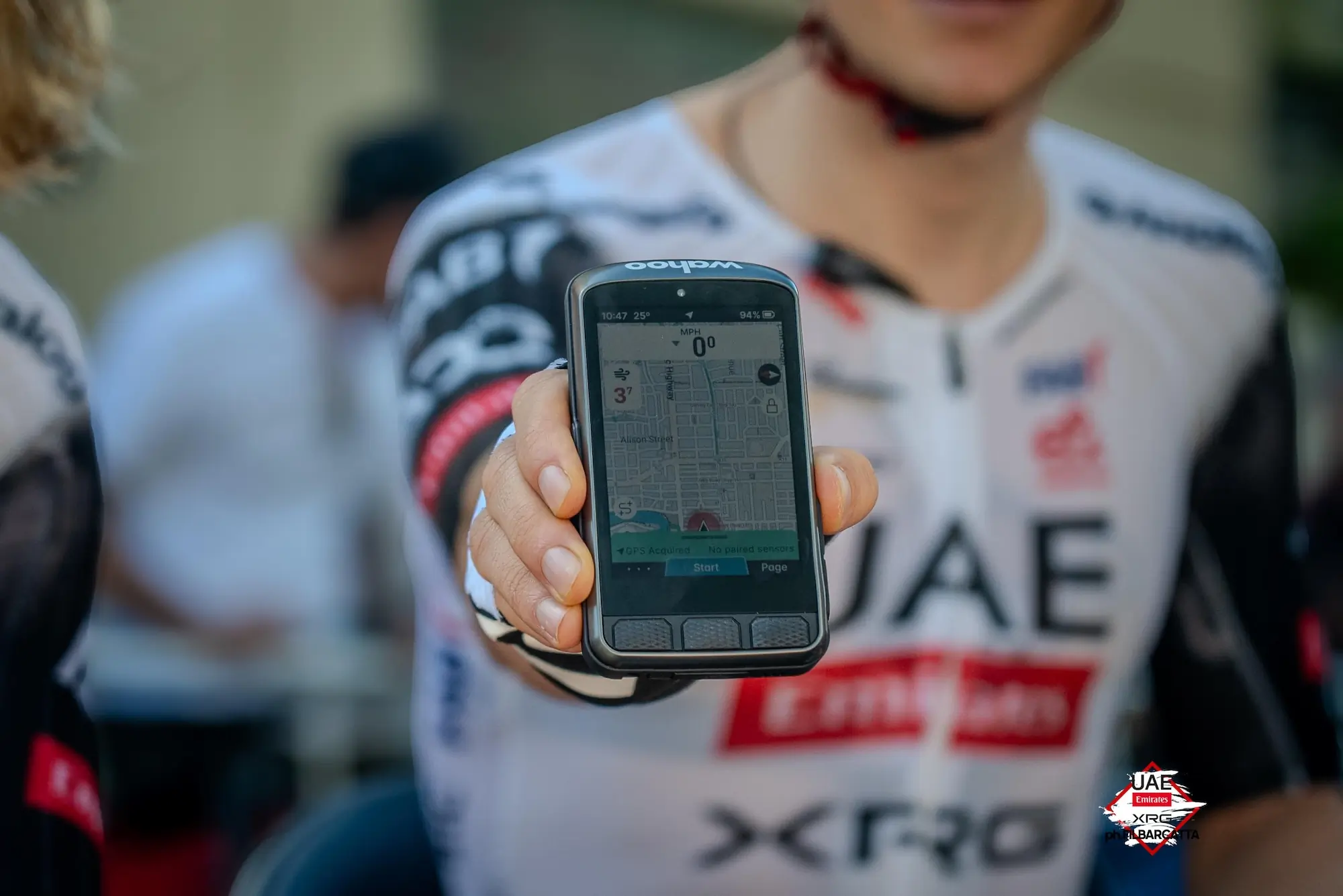 Cyclist holding GPS unit