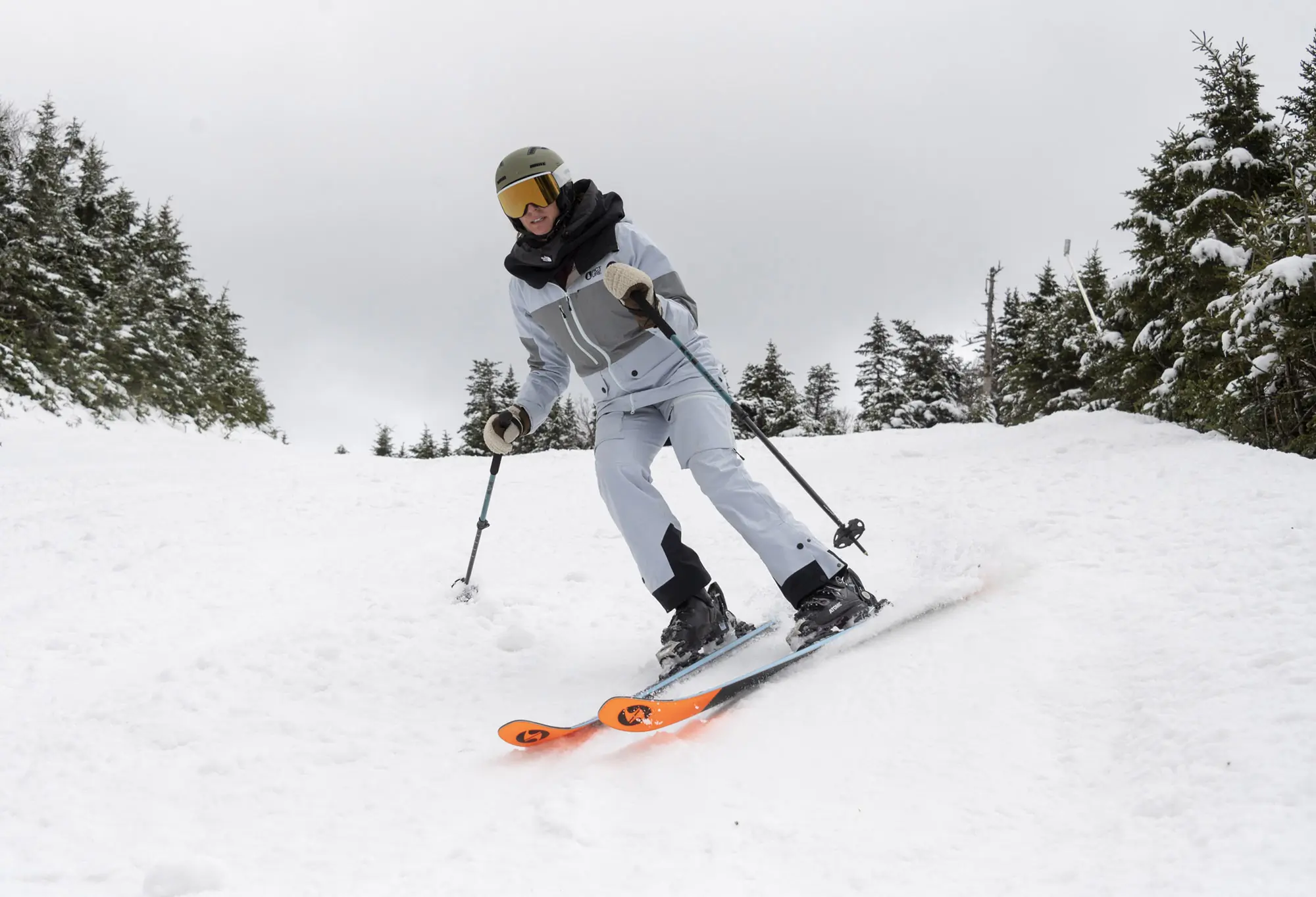A skier carving on groomed snow with Blizzard Black Pearl 88 skis
