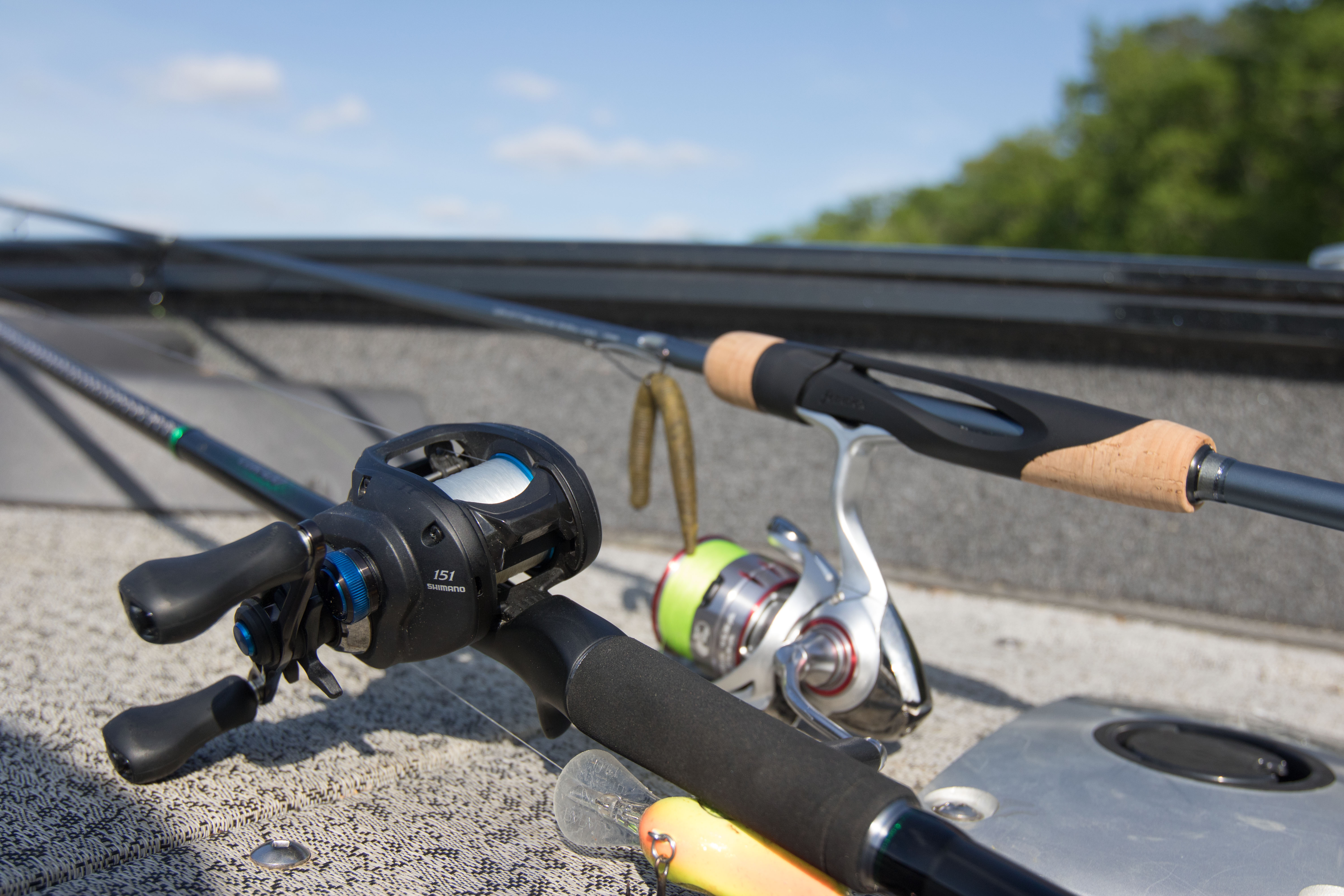 A baitcaster and a spinning rod and reel next to one another