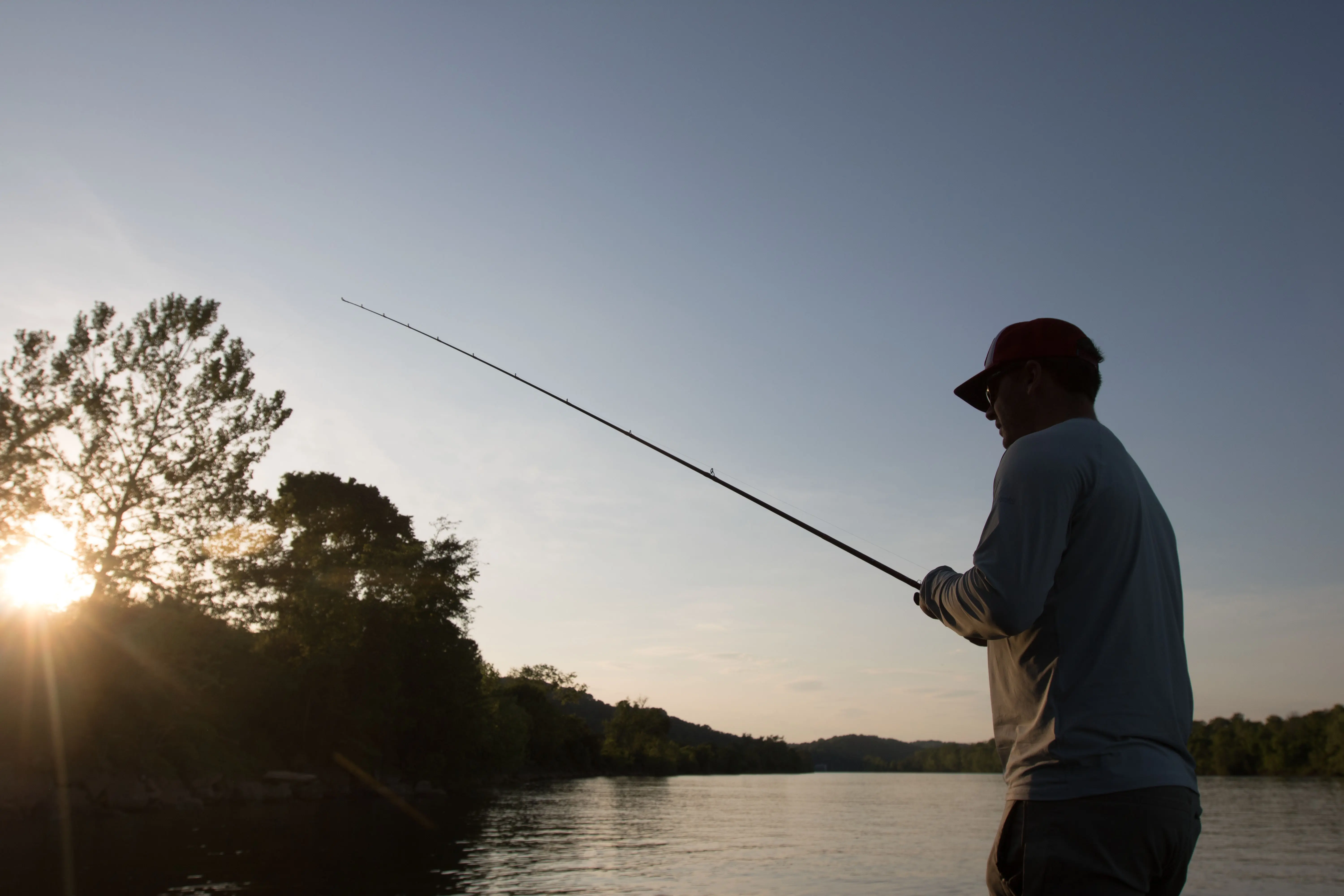 A bass angler fishing in the evening