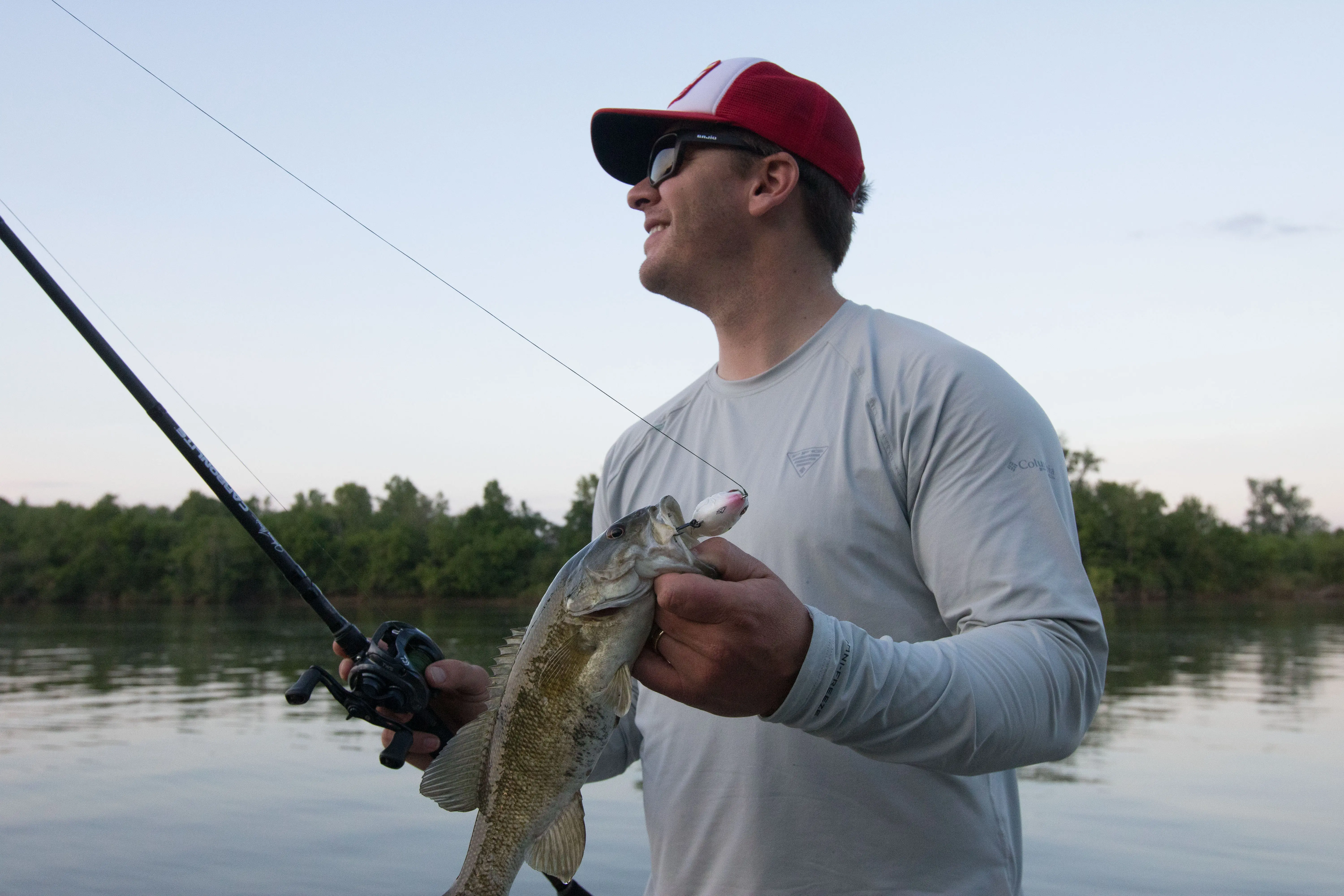 An angler holding a bass