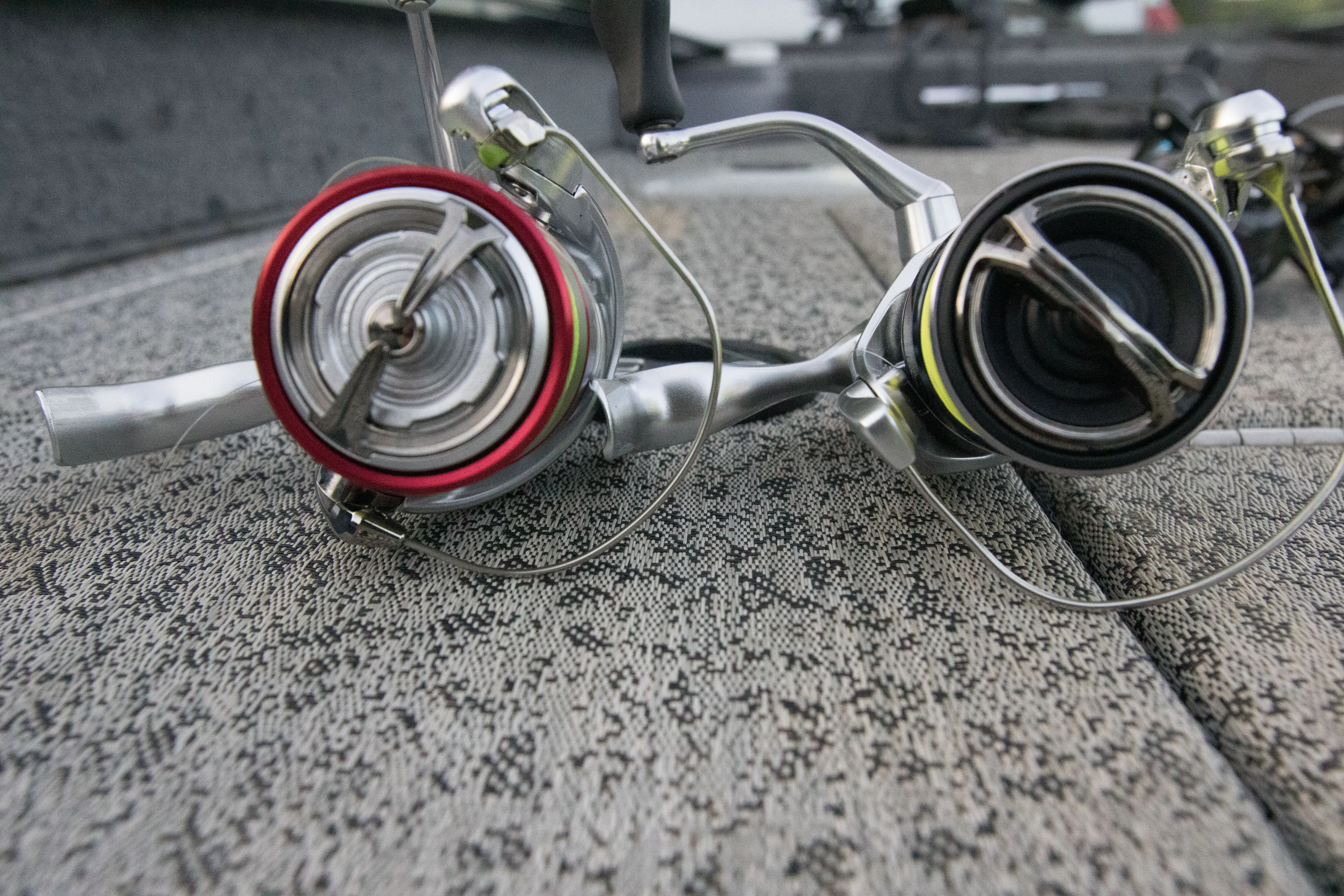 Two of the best bass fishing reels side by side, comparing spool size