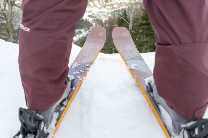 Blizzard Black Pearl 88 skis shown from behind a skier looking downhill