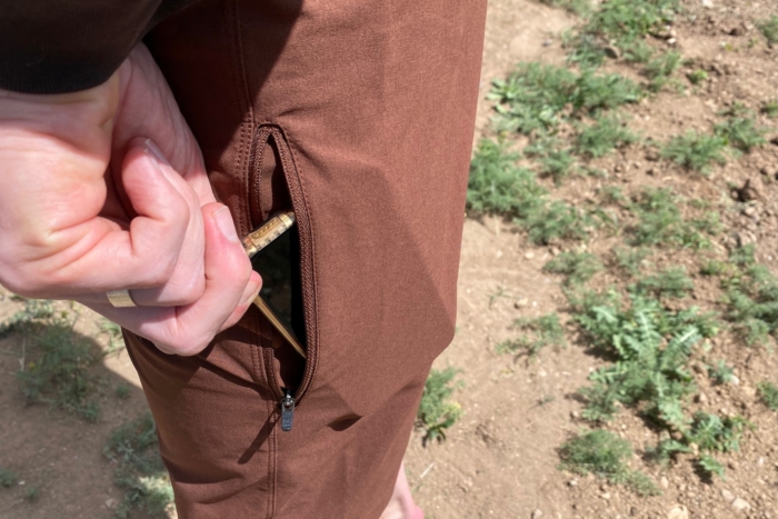 Pulling a phone out of the thigh pocket on the Sun Dog Shorts