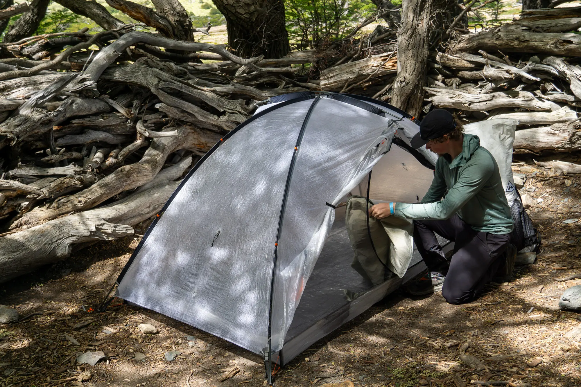 A hiker finalizes the setup of the Hyperlite Mountain Gear CrossPeak 2 tent in Patagonia
