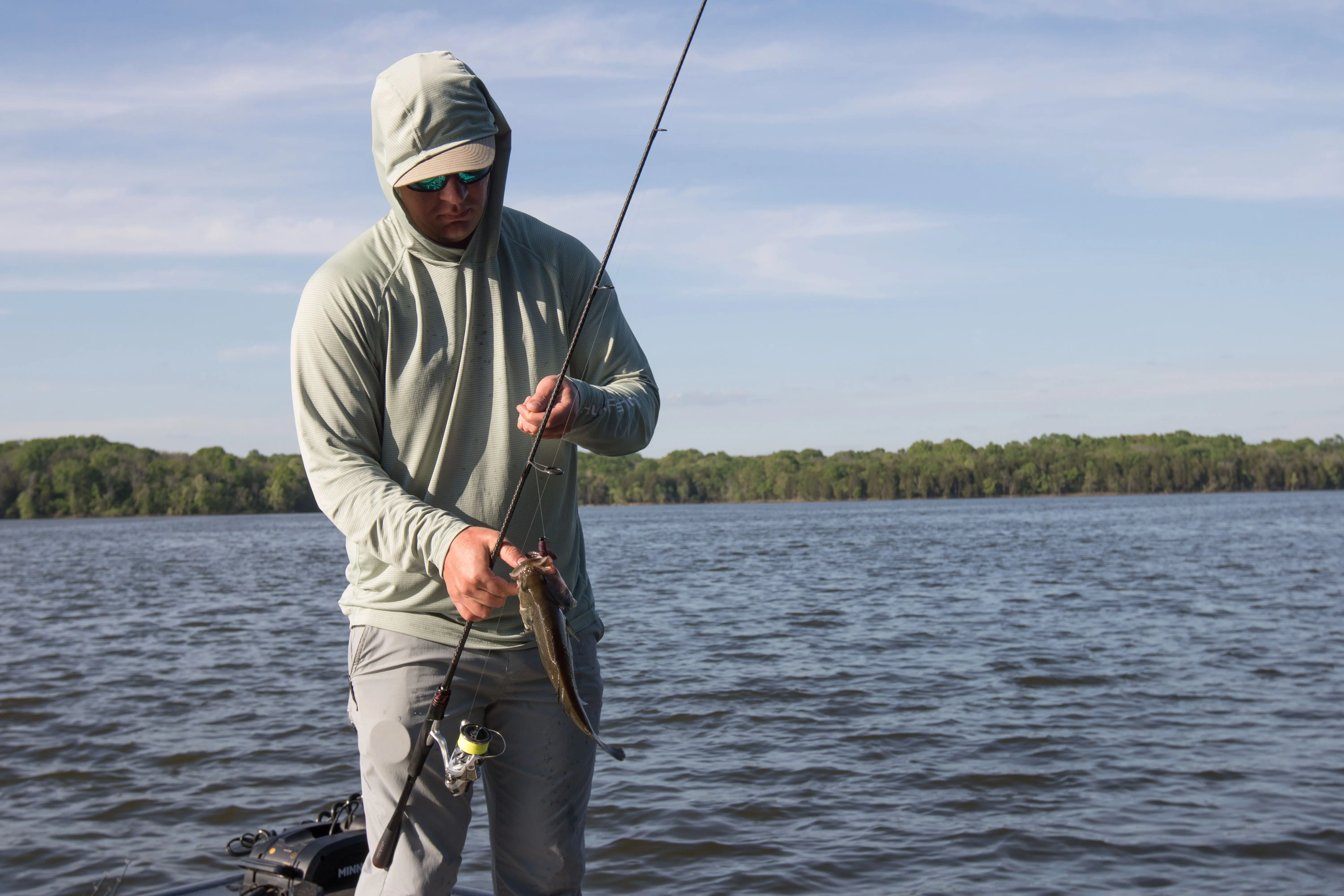An angler unhooking a fish.