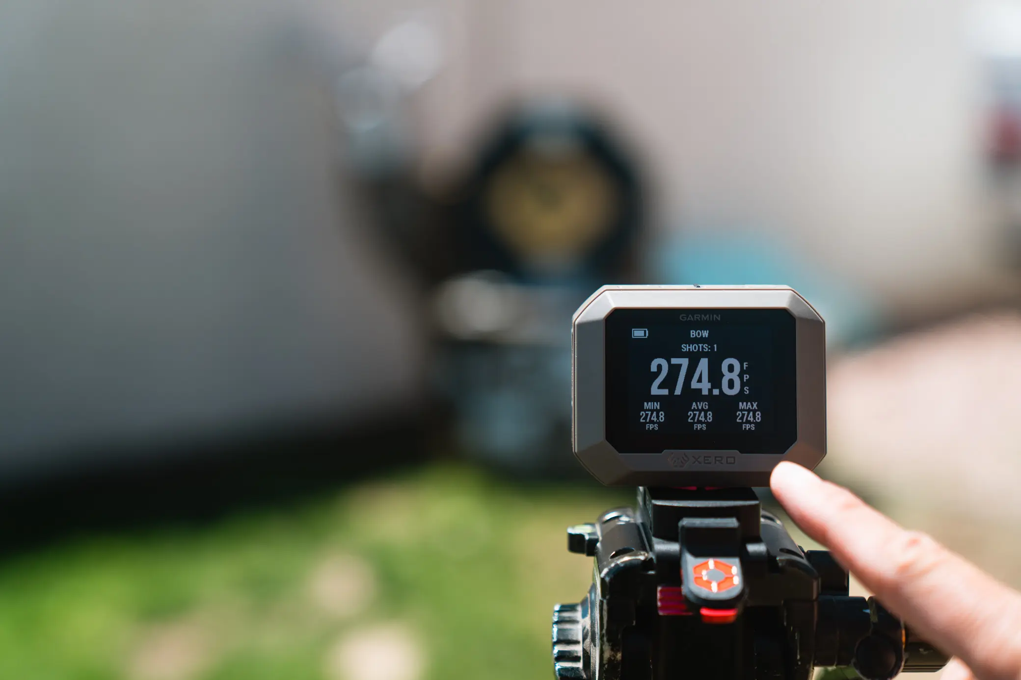 adjusting Garmin Xero C1 Pro with blurred background