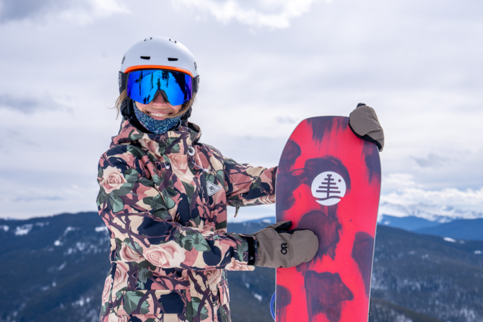 snowboarder holding snowboard upright