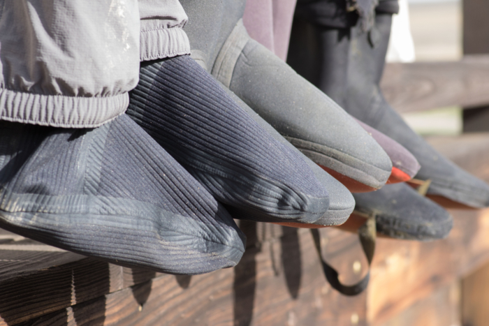 The booties of the Simms Flyweight wader lined up with other waders