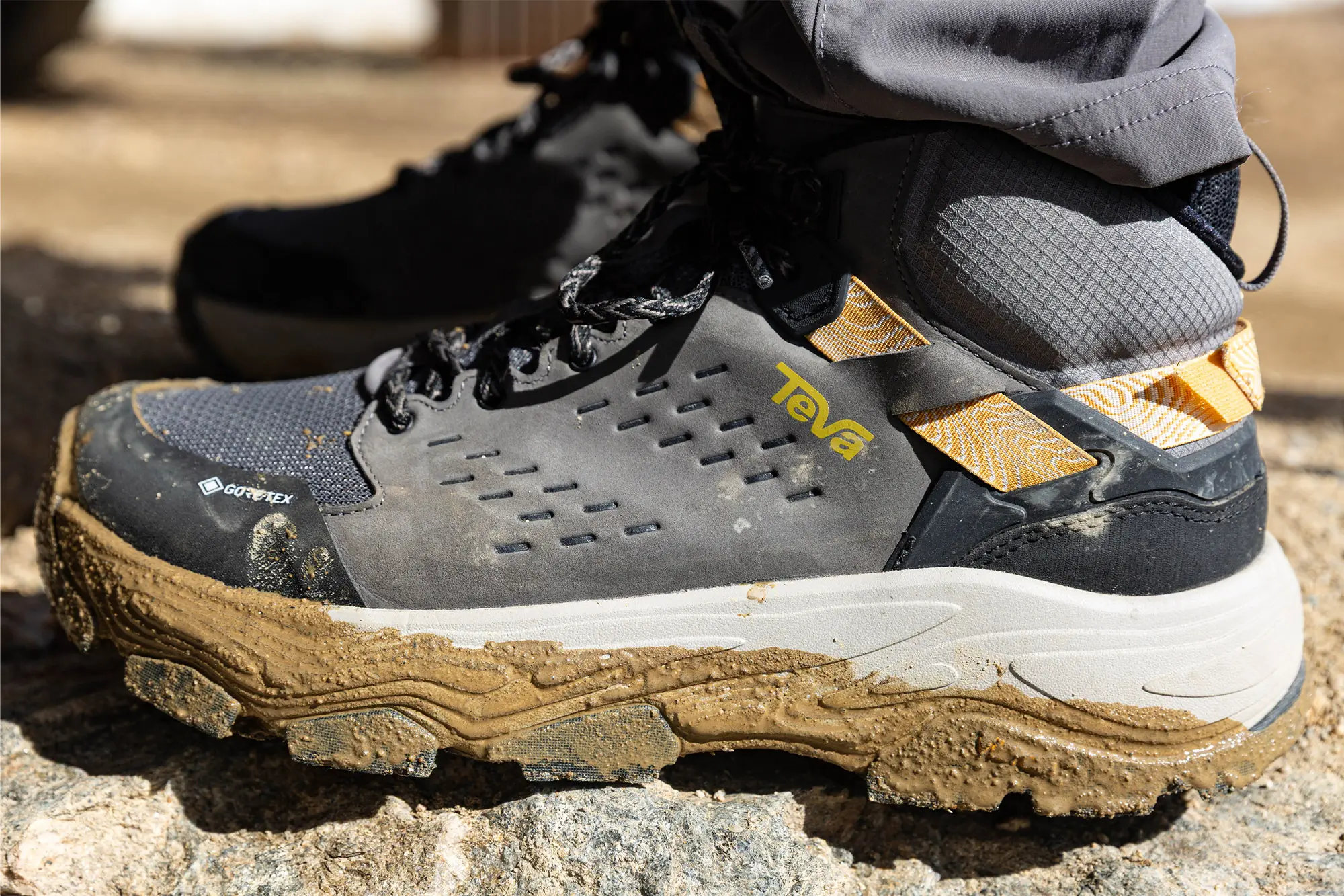 Teva Grandview Max GTX hiking boot shown from the side, covered in dry mud