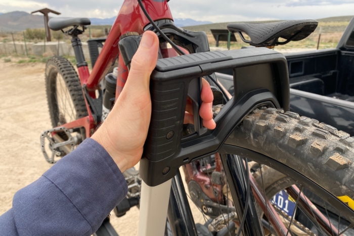 squeezing the release handle on the wheel hook of the Verse hitch rack