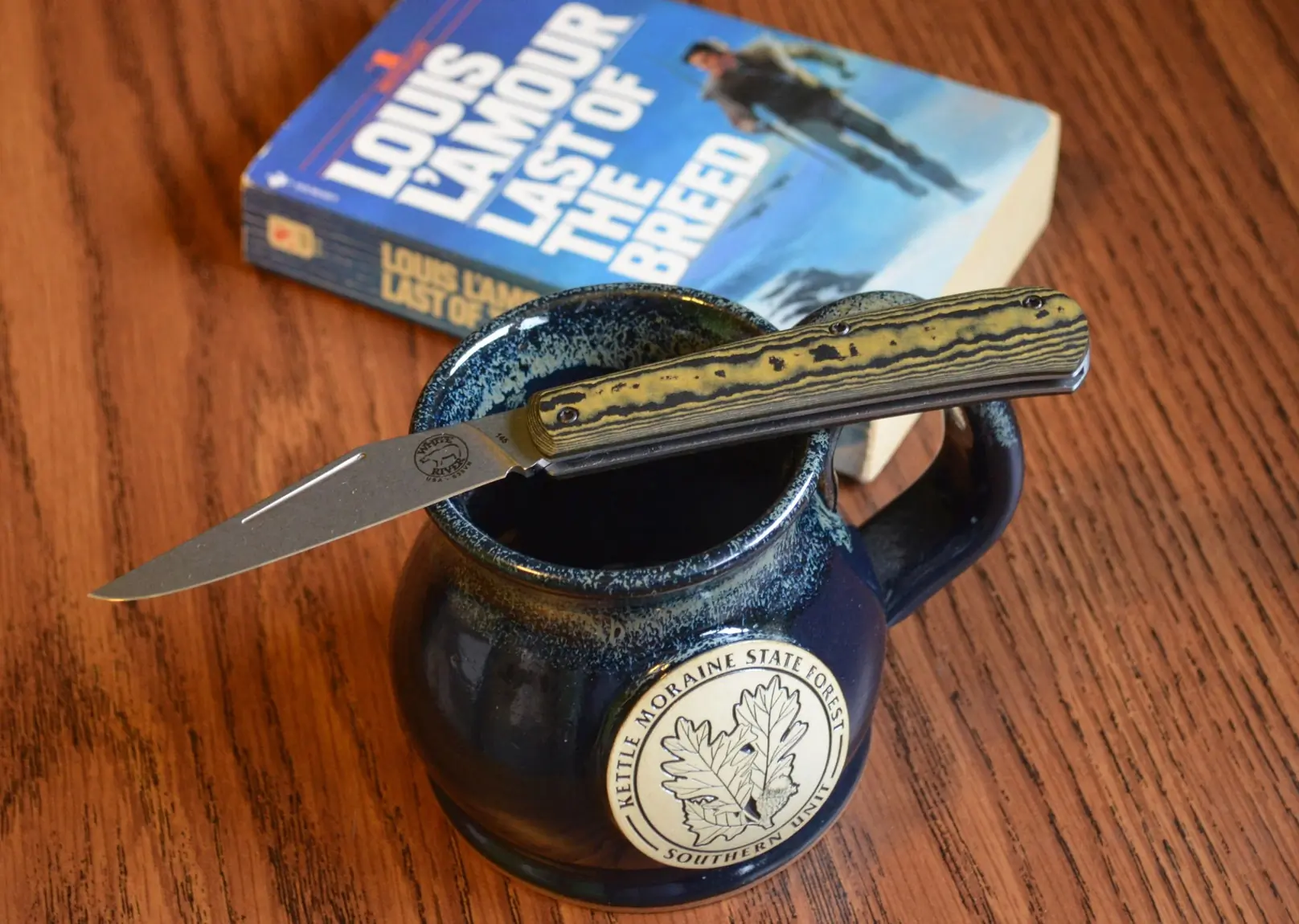 Trailhead Trapper resting on a coffee mug