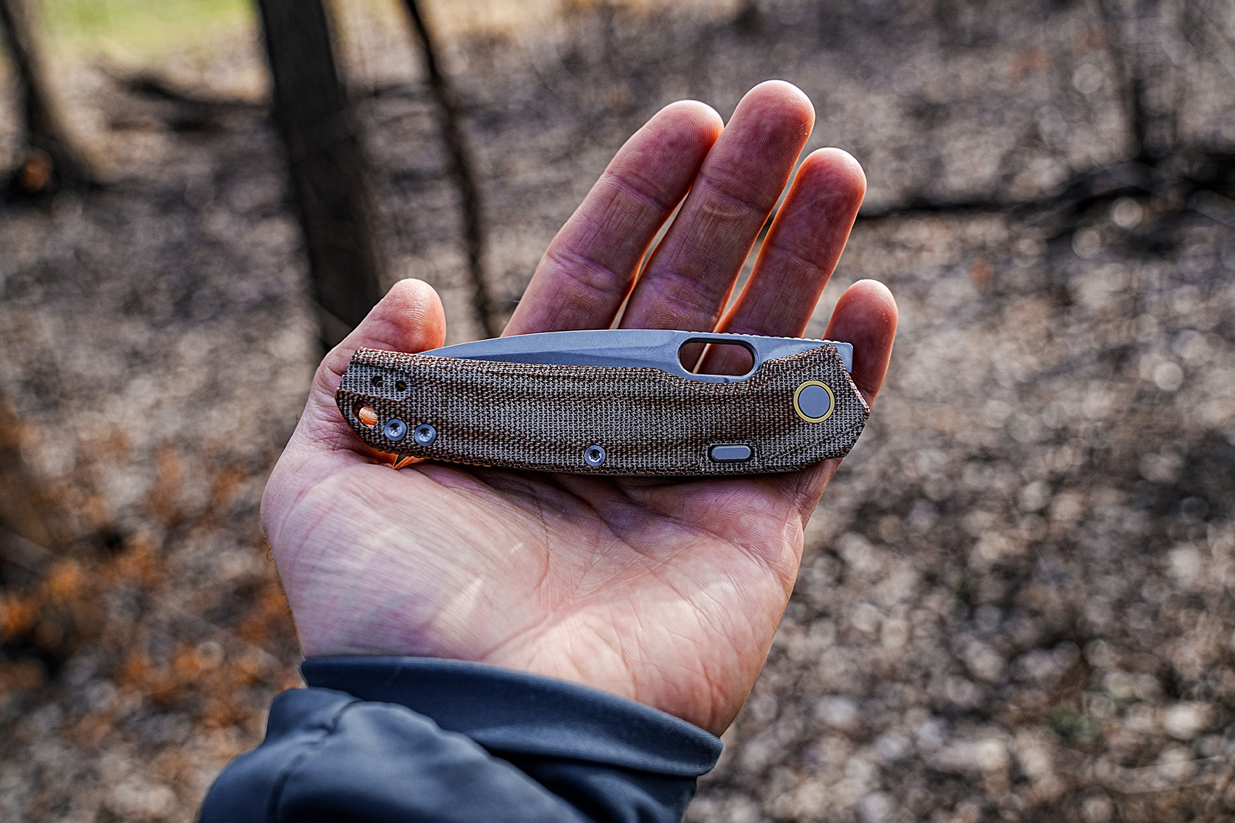 Vosteed Psyop Micarta knife shown closed in hand outdoors