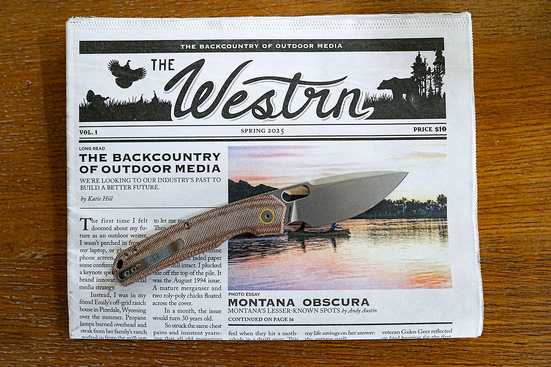 Vosteed Psyop Micarta knife resting on an outdoor magazine cover