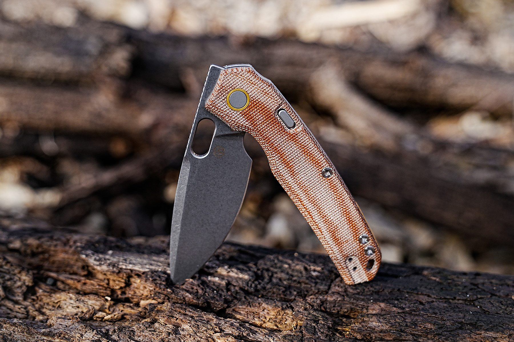 Vosteed Psyop Micarta knife standing open on a fallen log