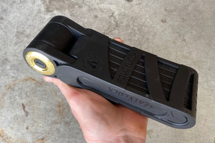 Holding the Foldylock Forever in hand to demonstrate its folded size