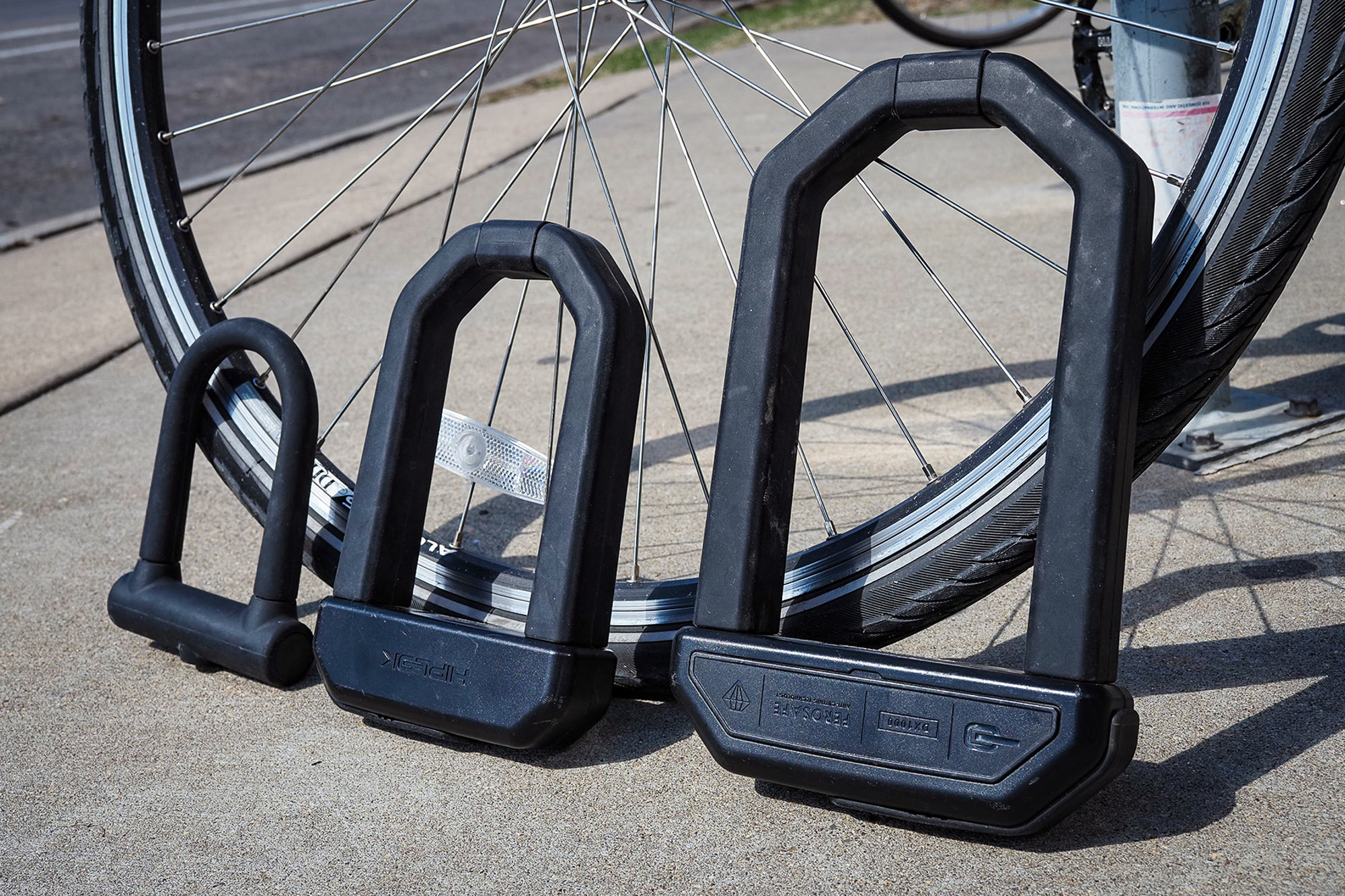 A standard bicycle U-lock, Hiplok D1000, and Hiplok DX1000, L to R; (photo/Adam Ruggiero)