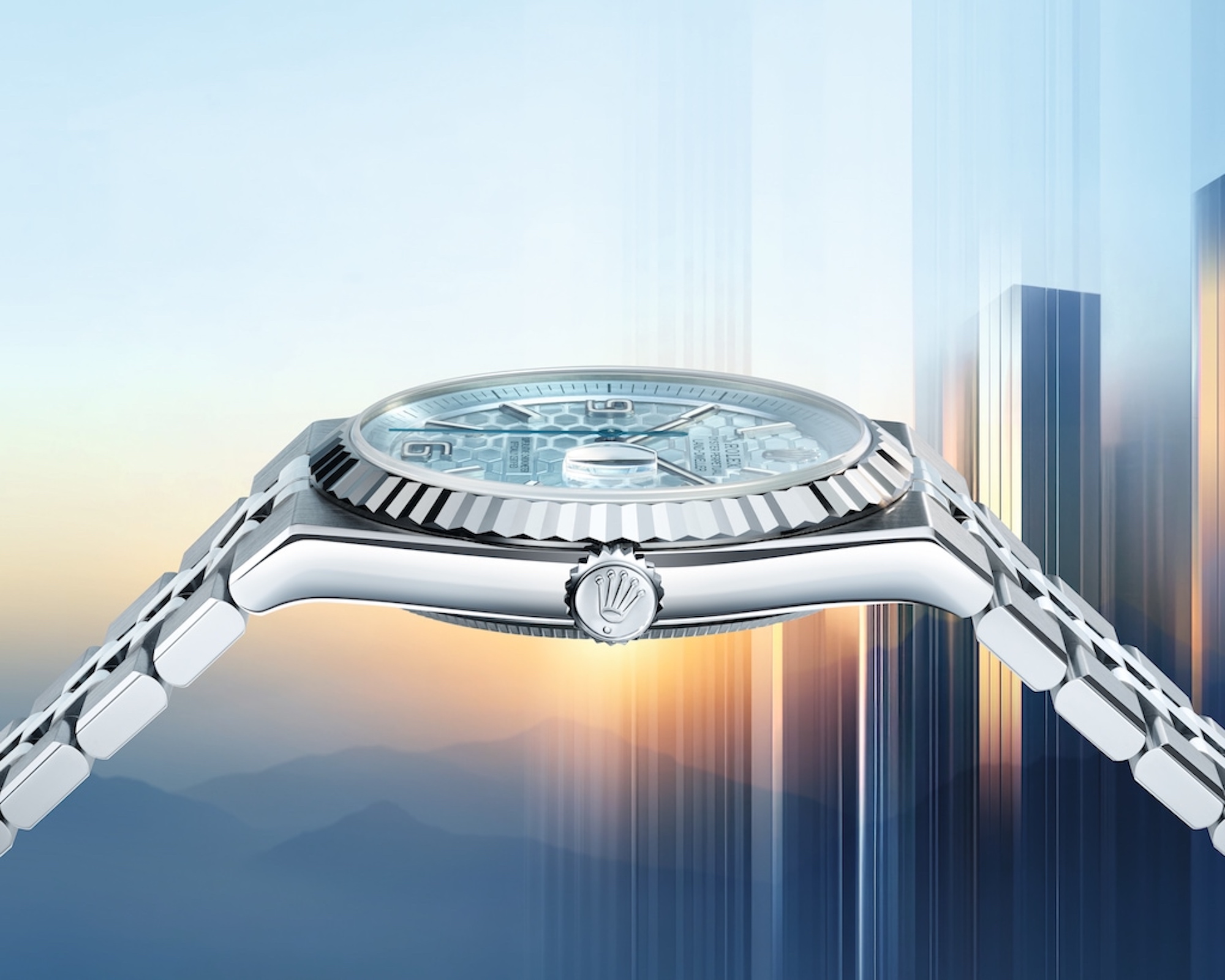 side view of watch with mountains and skyscrapers behind