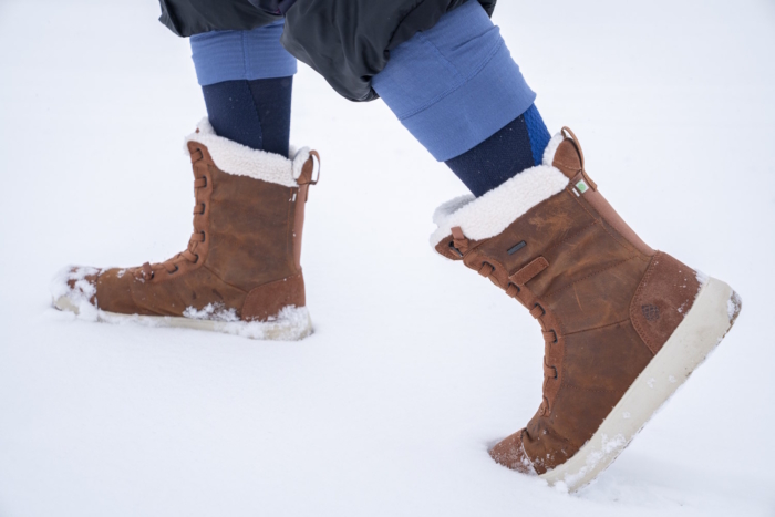 Person walking in snow wearing stio women's colter winter boot