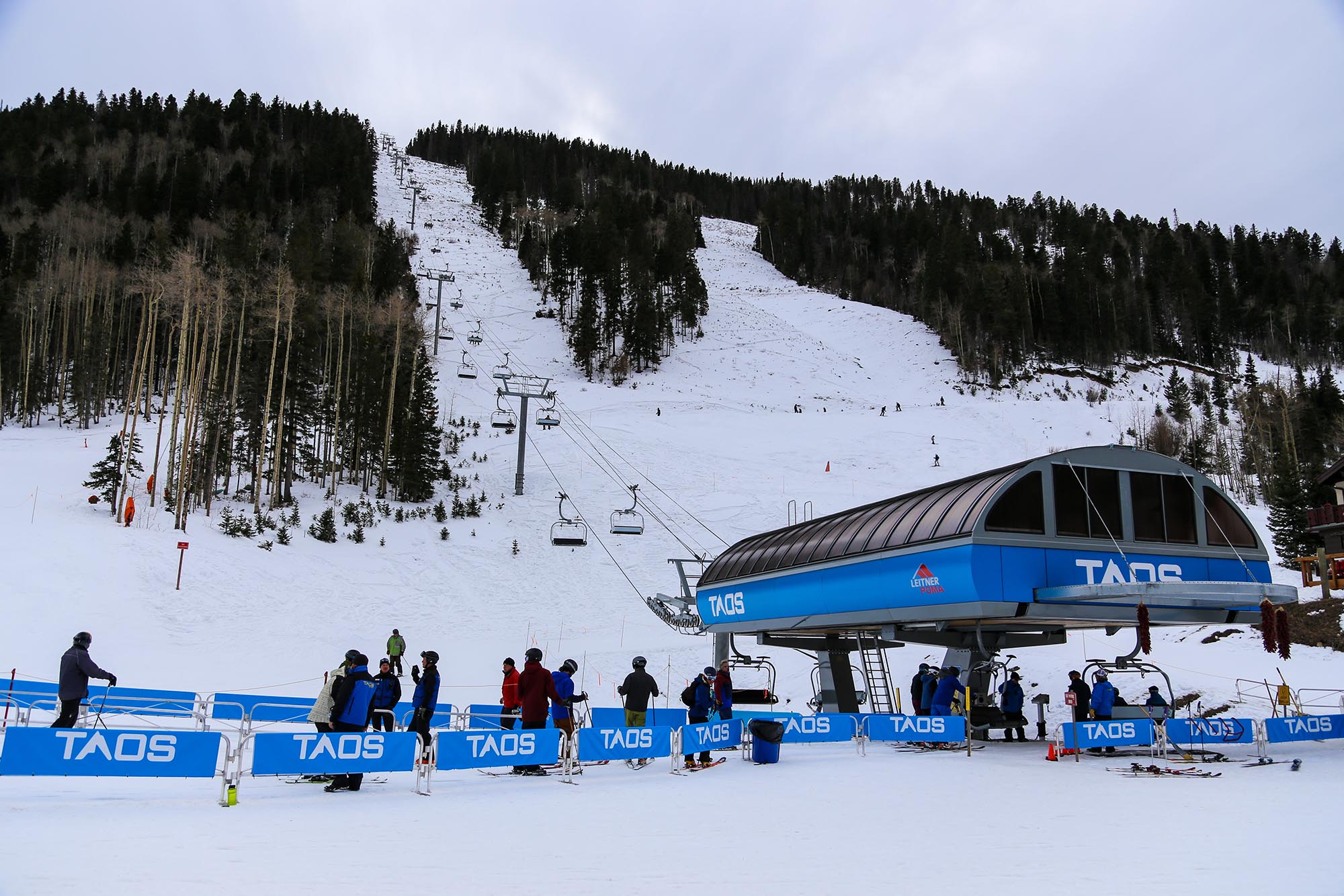 Taos, New Mexico / USA November 22, 2018 Ski lift and people waiting in line for the new quad lift at Taos Ski Valley resort