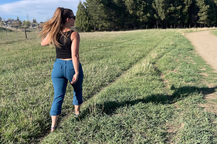 Woman wearing Gnara go there pants walking in fields