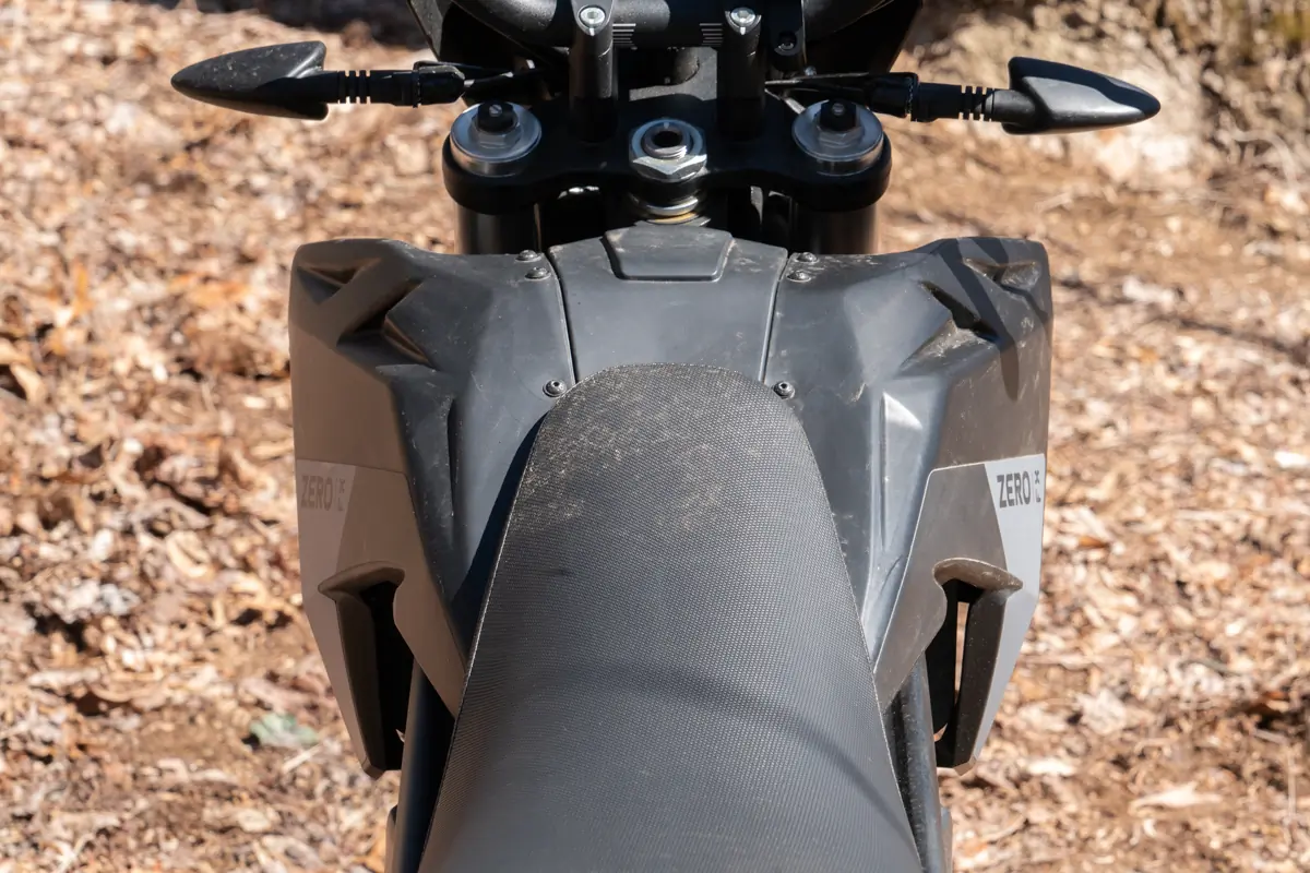 The rear seat of the Zero FX electric motorcycle, with a textured surface and sleek design