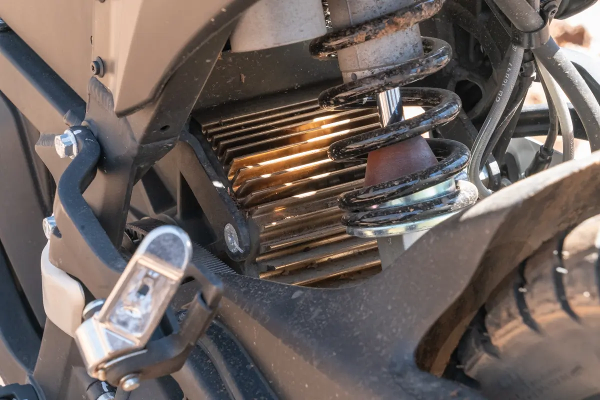 A close-up of the shock and cooling fins on the Zero FX electric motorcycle's rear suspension system