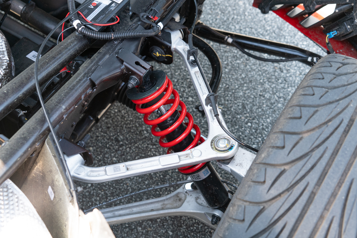 Polaris Slingshot R close-up of the front suspension with red coil spring and control arms