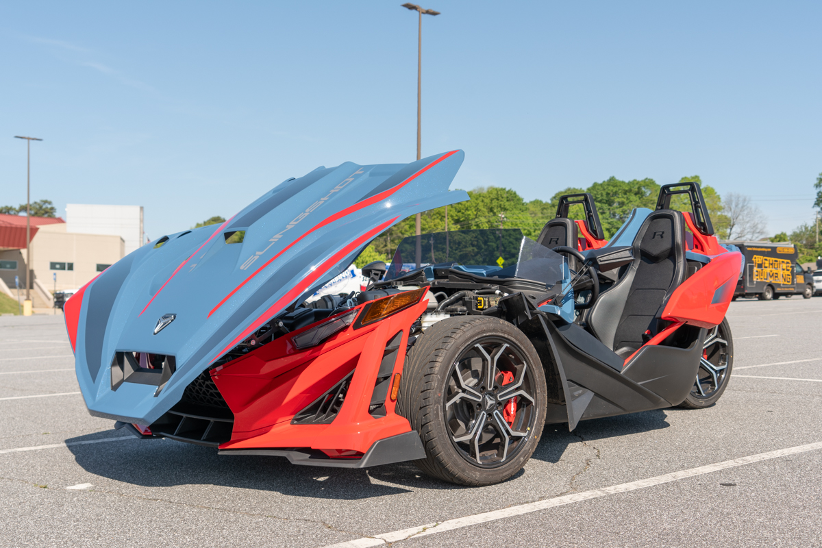 Polaris Slingshot R front three-quarter view with hood open, showcasing its aggressive styling and exposed engine bay