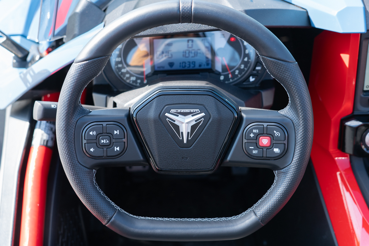 Polaris Slingshot R steering wheel with integrated media and cruise control buttons, and digital dashboard in background