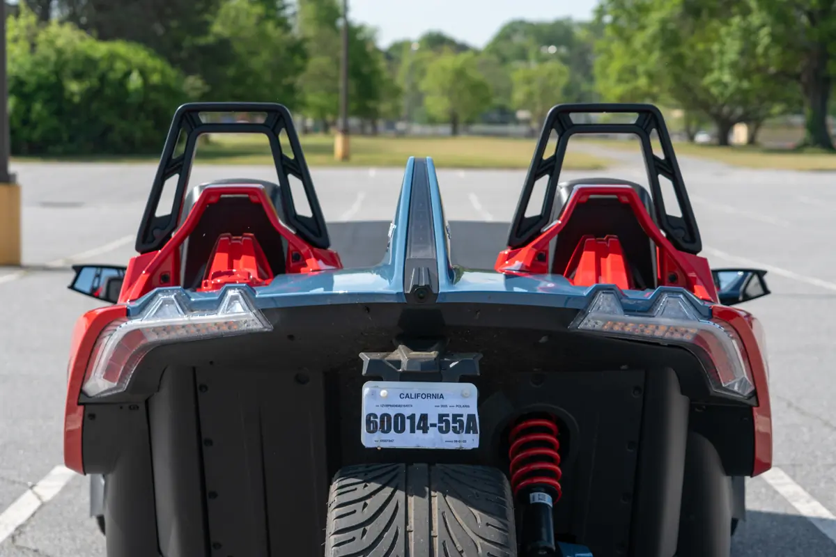 Polaris Slingshot R rear view showing single rear wheel, suspension, and twin seats with roll bars