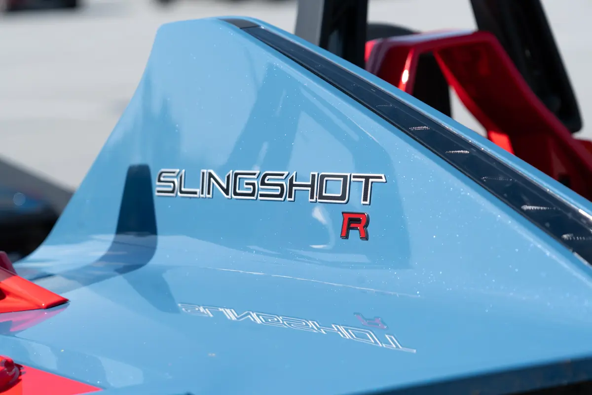 Polaris Slingshot R logo badge displayed on the rear body panel in metallic blue finish