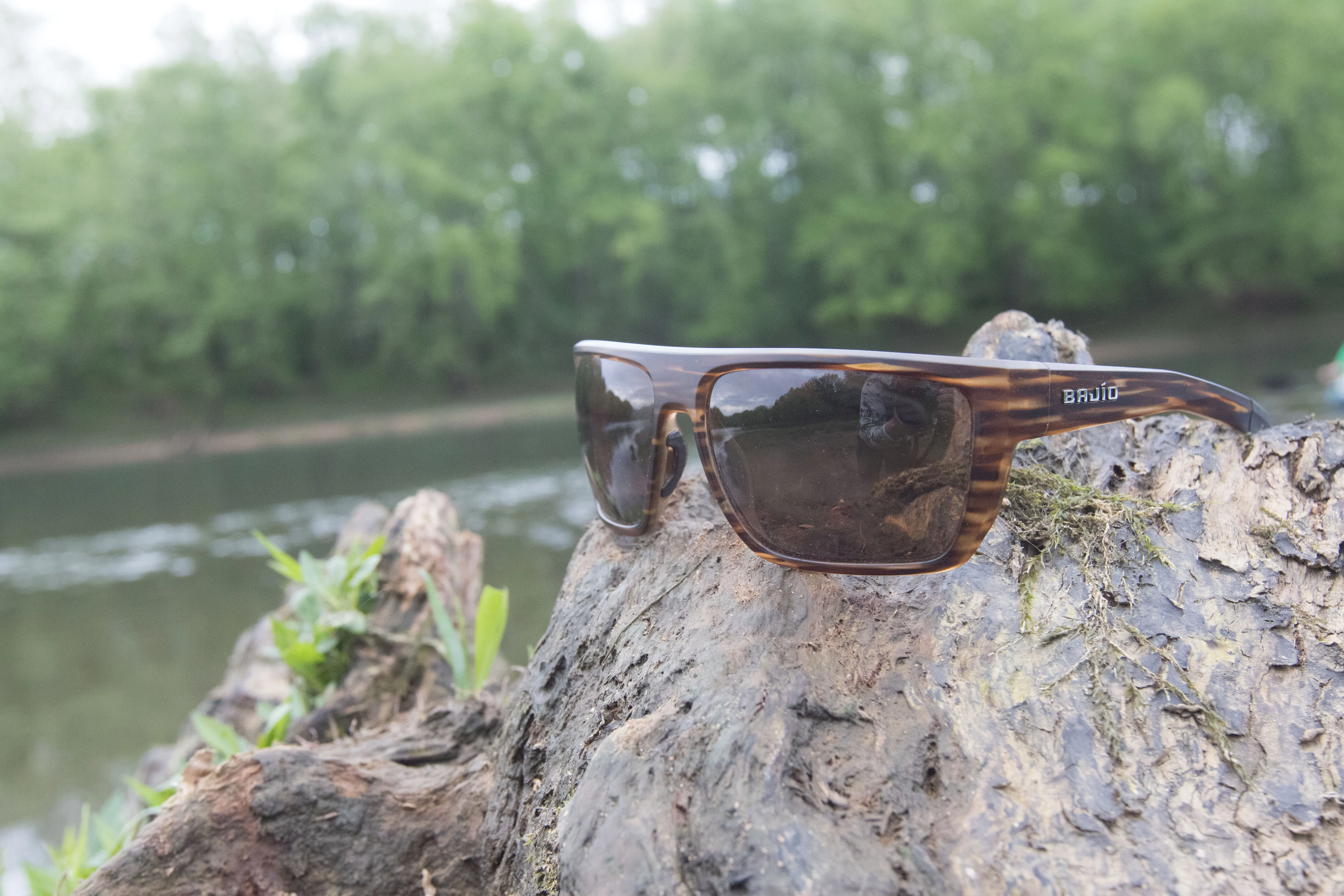 The Bajio Zapita sunglasses next to a river