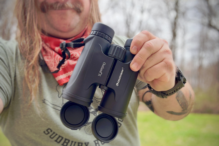 Celestron Outland X 10x42 held in hand outdoors