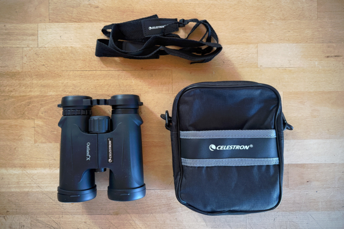 Celestron Outland X 10x42 shown with case and strap