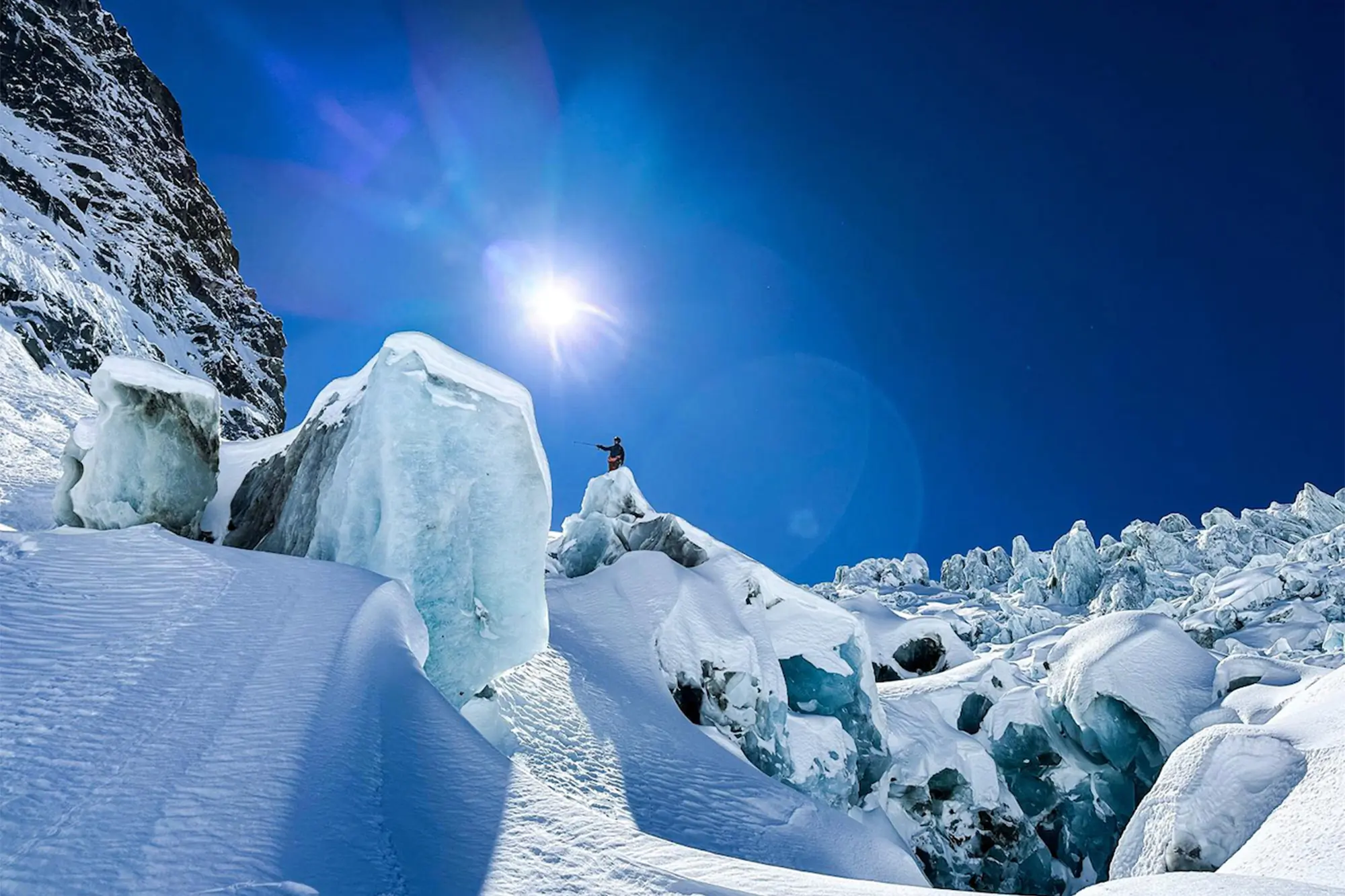 Vivian stands atop a glacier surrounded by towering ice blocks