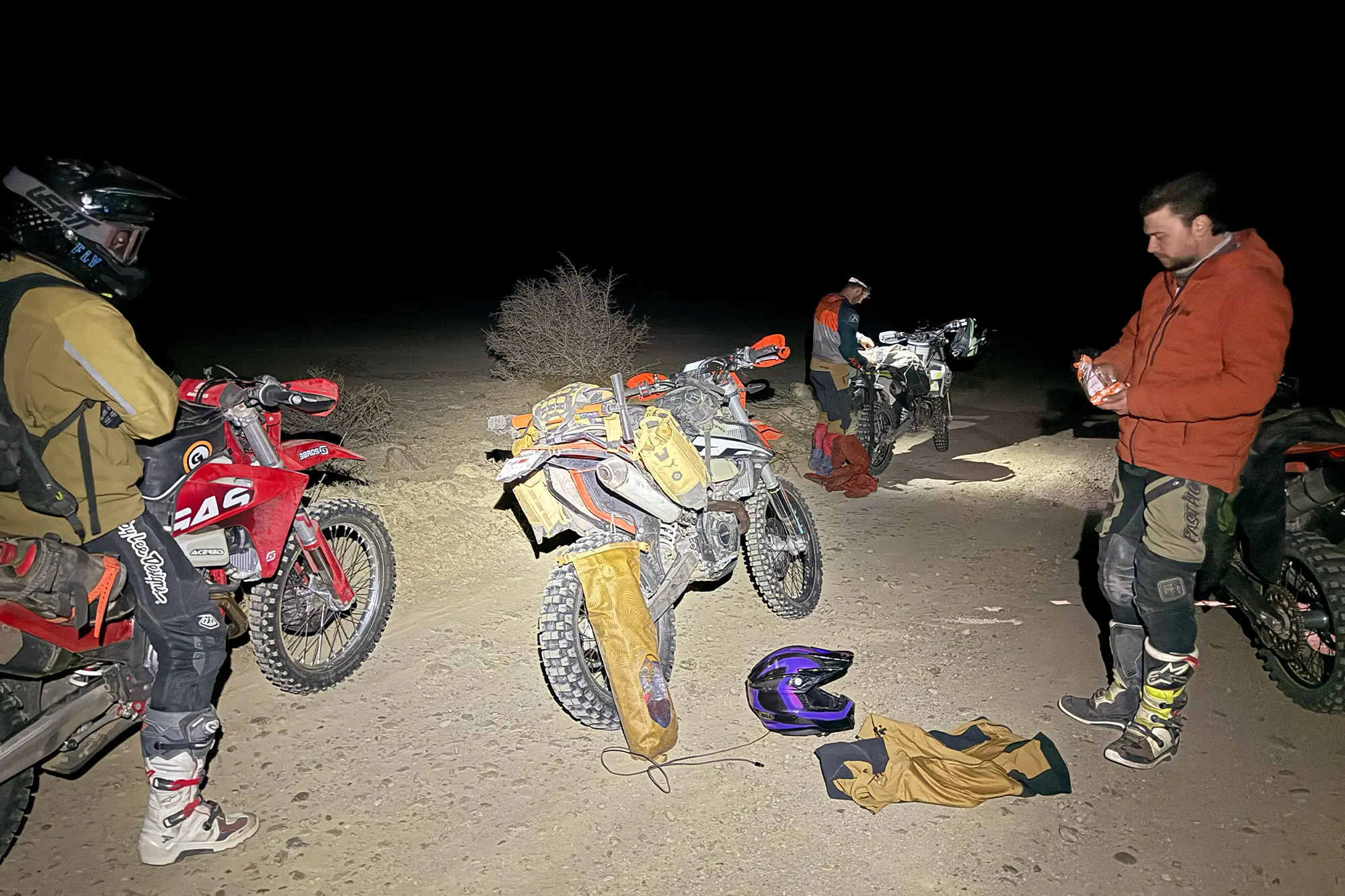 Mosko Moto Reckless 40L System V4.0 visible during a night stop with multiple riders resting