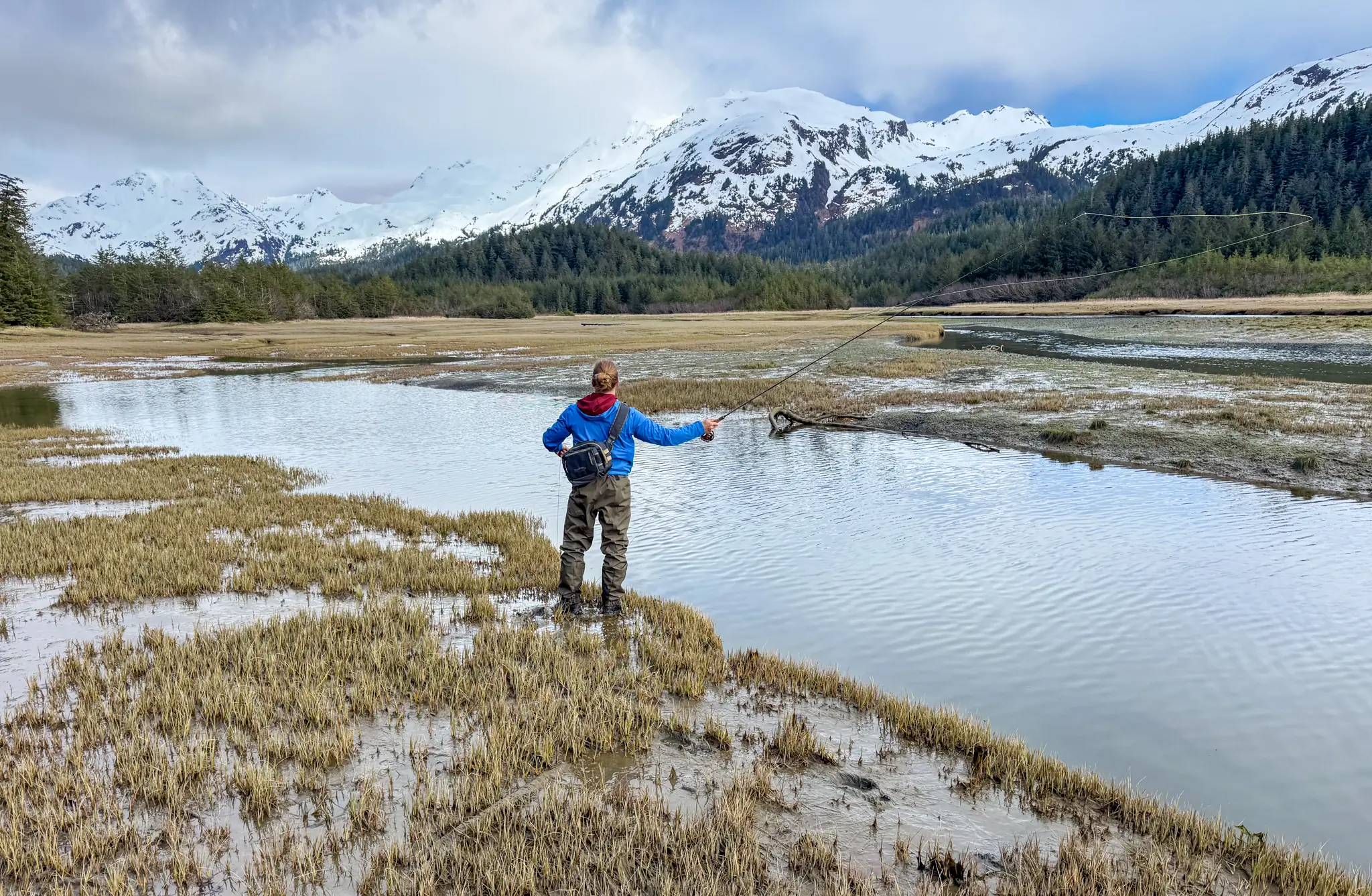 Patagonia Swiftcurrent Traverse Waders during fly casting in a muddy marsh near a stream