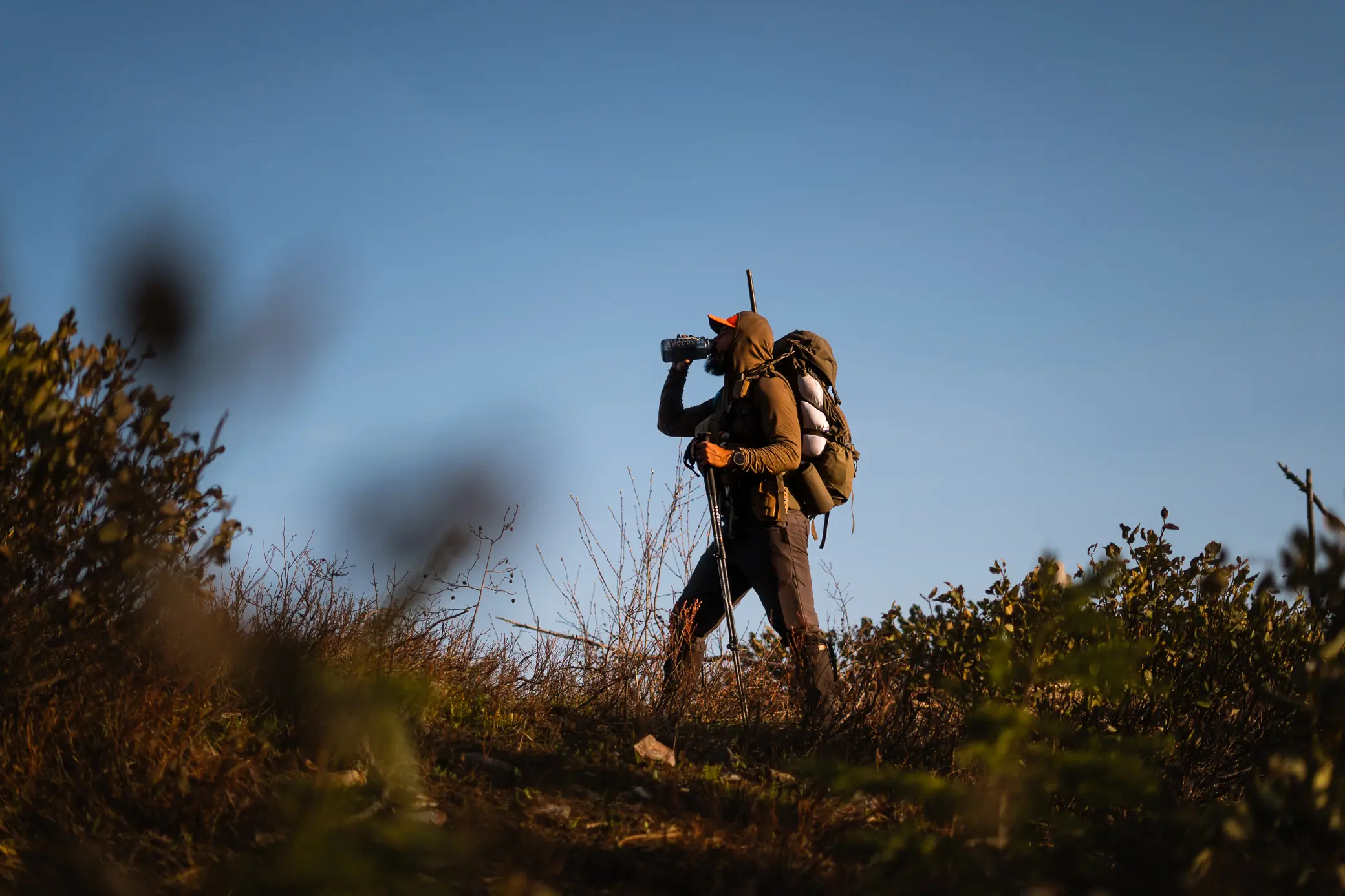 Garmin Tactix 8 Smartwatch worn while hiking with a large backpack