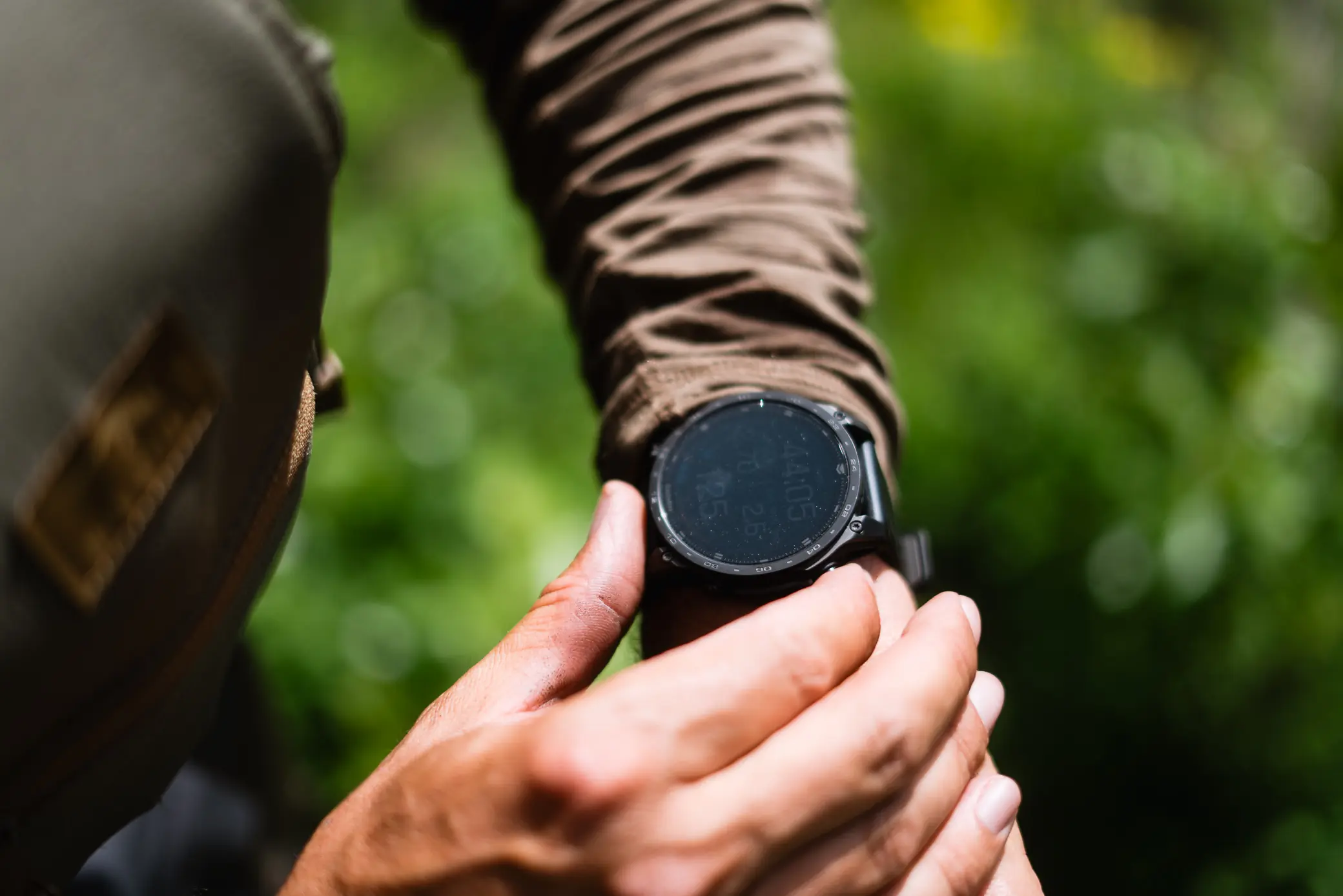 Garmin Tactix 8 Smartwatch showing altitude and pace in a forested setting