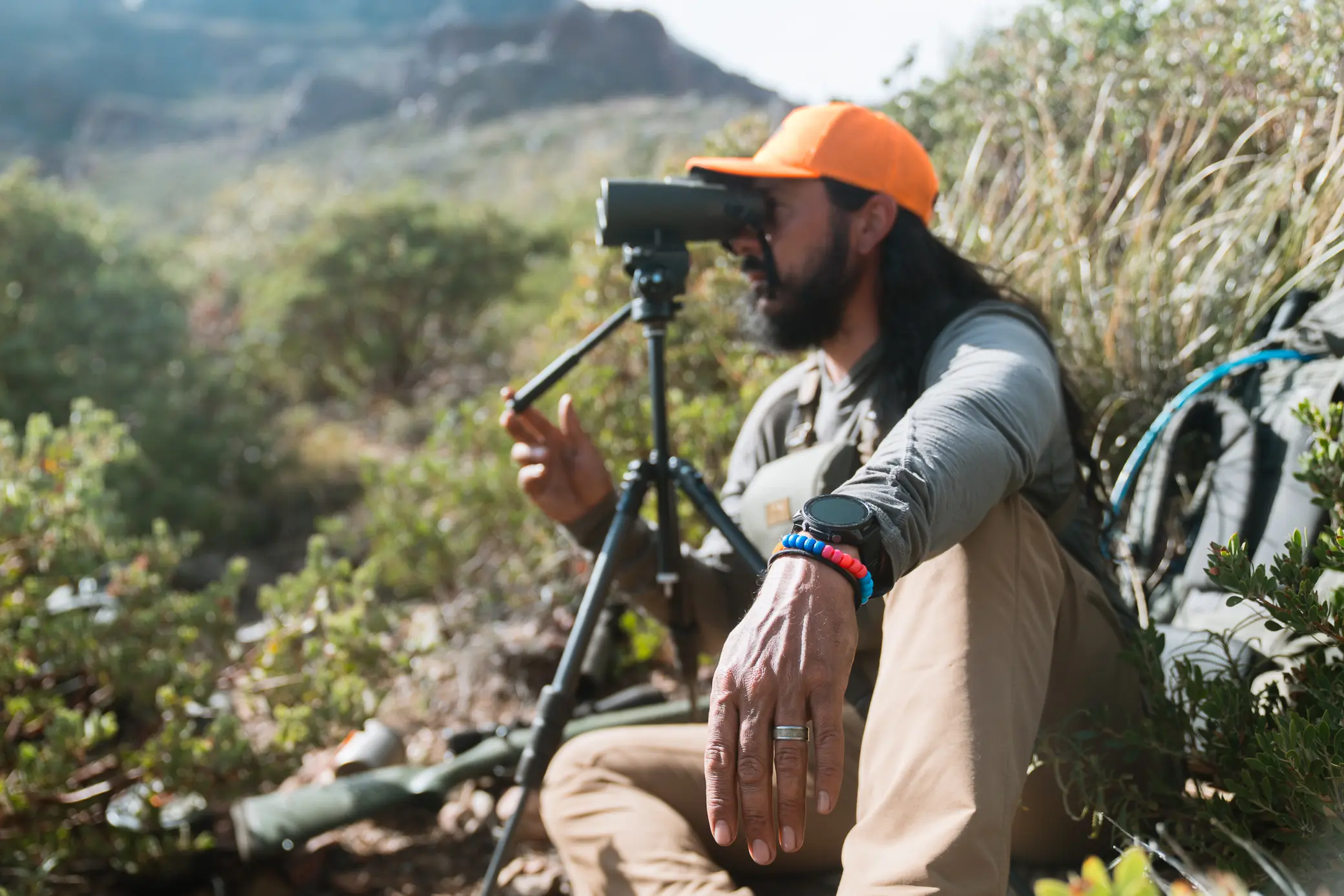 Garmin Tactix 8 Smartwatch visible while glassing terrain through binoculars