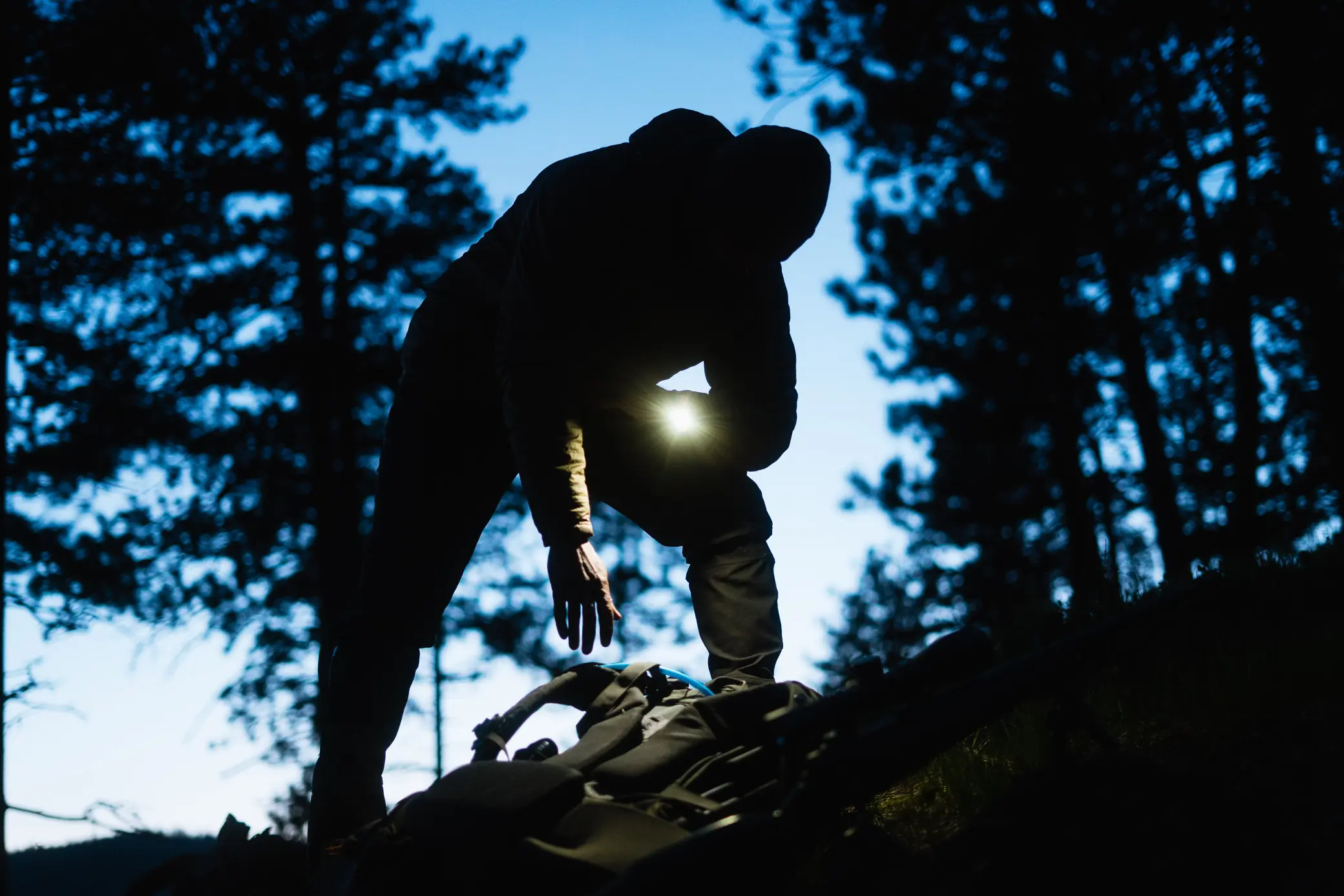 Garmin Tactix 8 Smartwatch flashlight in use before sunrise in the forest