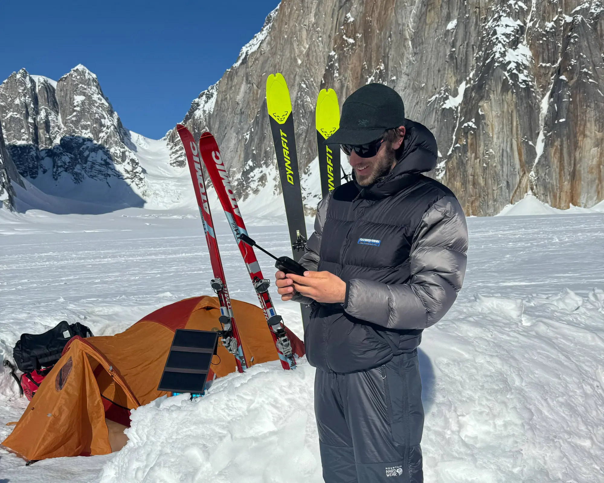 a climber dials in on the iridium 9555 satellite phone in the ruth gorge in alaska