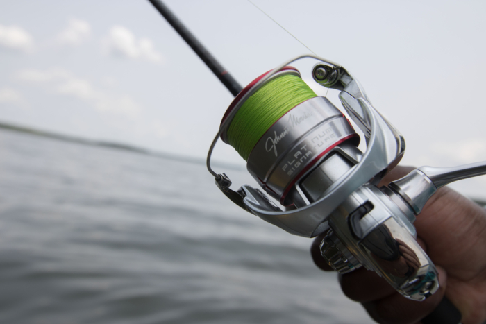 The Johnny Morris Platinum Signature spinning reel on a lake