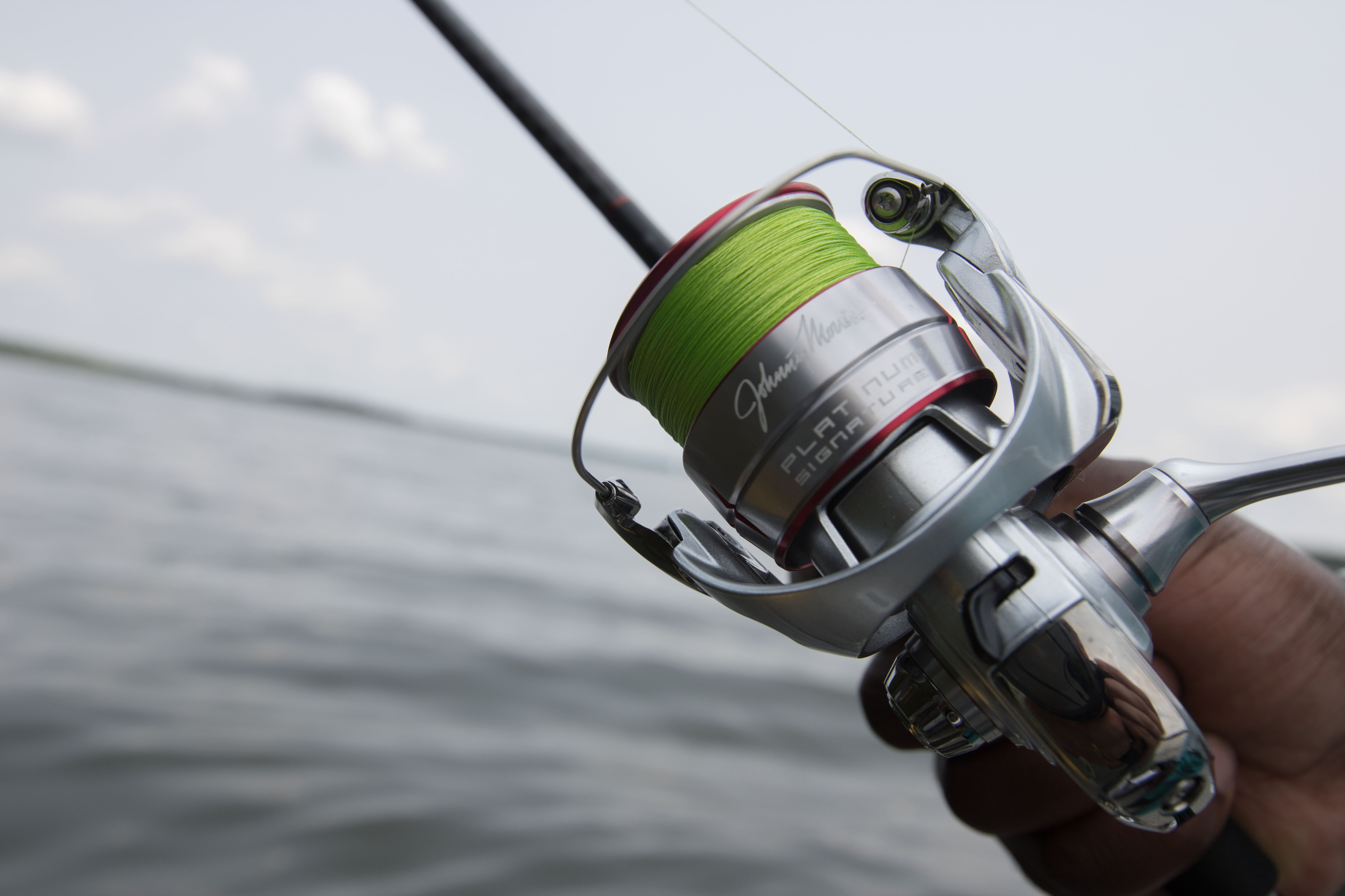 The Johnny Morris Platinum Signature spinning reel on a lake