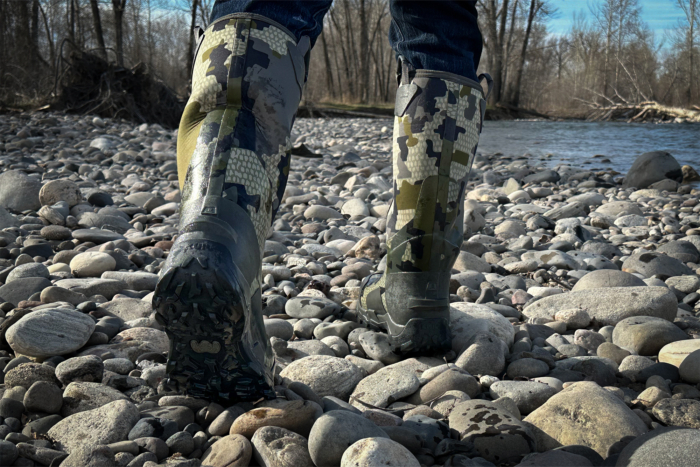 KUIU HD Mud Boot walking across a rocky riverbank