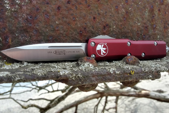 Microtech UTX-85 resting on a rusted metal surface