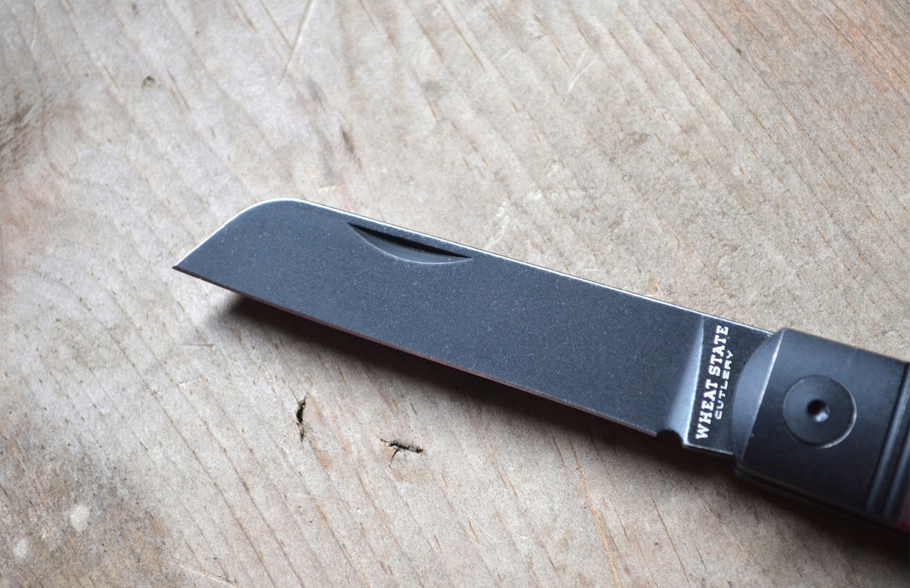 Wheat State Cutlery Peacemaker blade close-up on wood