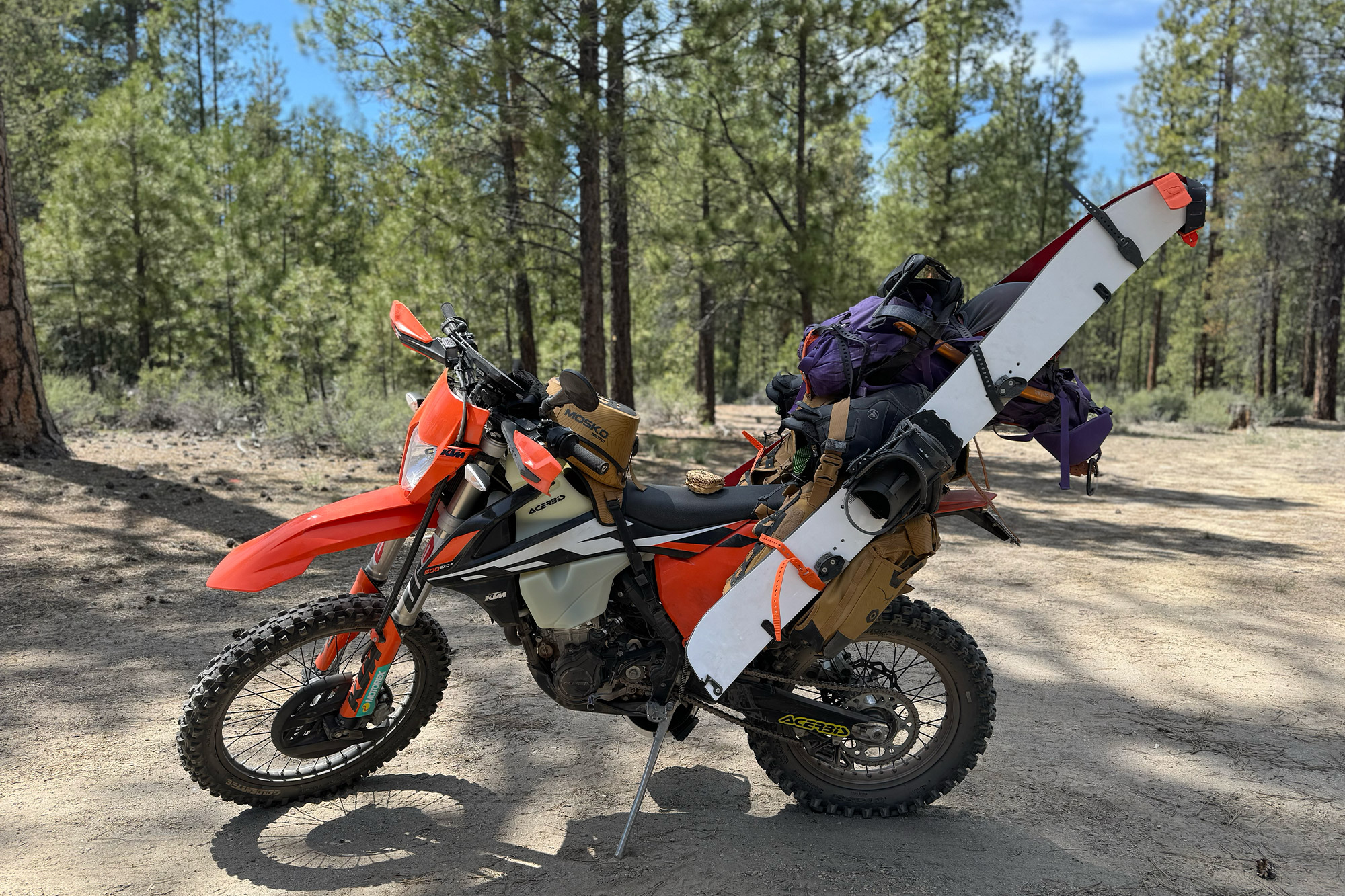 Mosko Moto Reckless 40L System V4.0 loaded with gear and skis on a parked adventure motorcycle